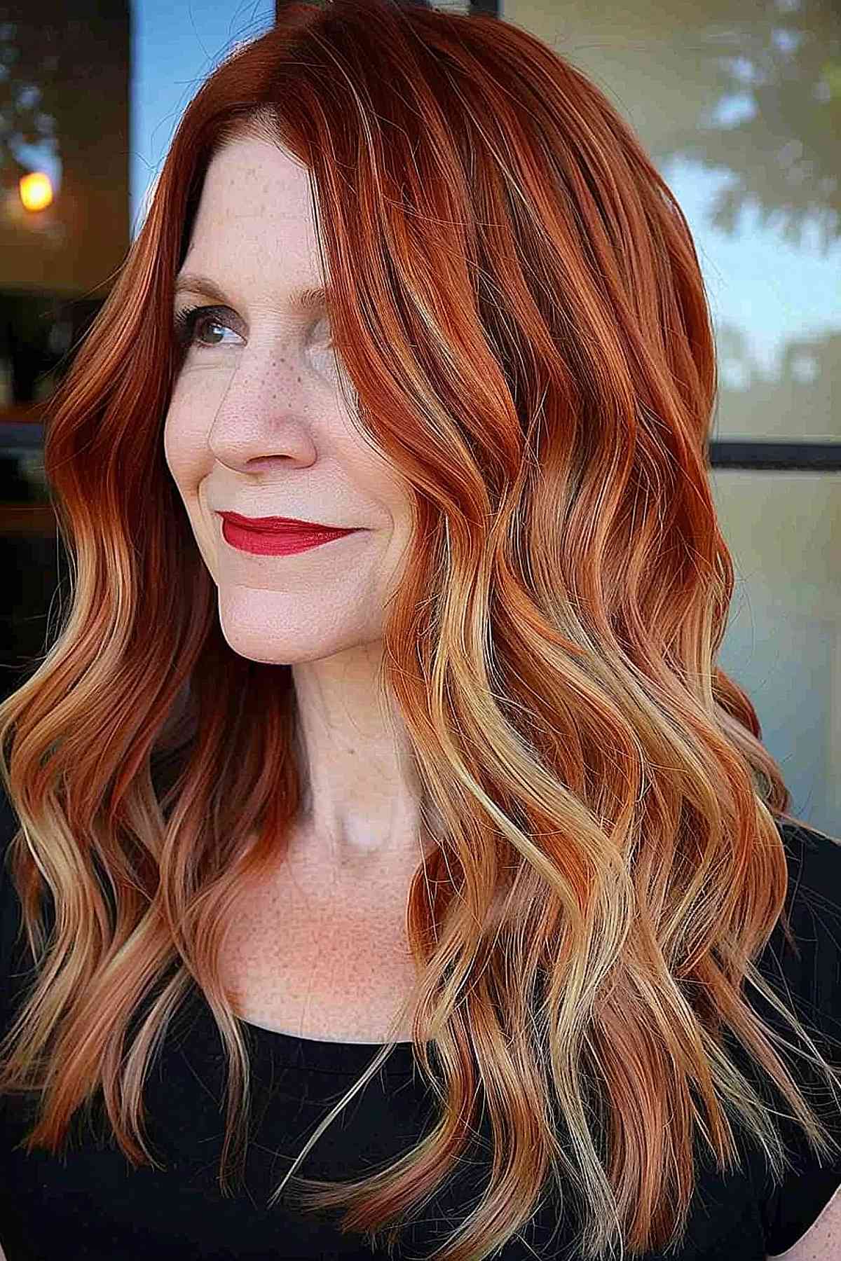 Polished ginger copper with blonde highlights for women over 40