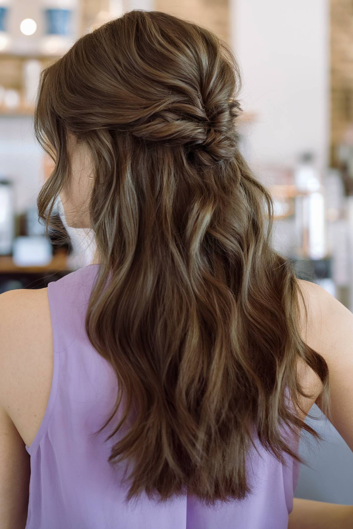 Half-up wavy hairstyle with twisted detail