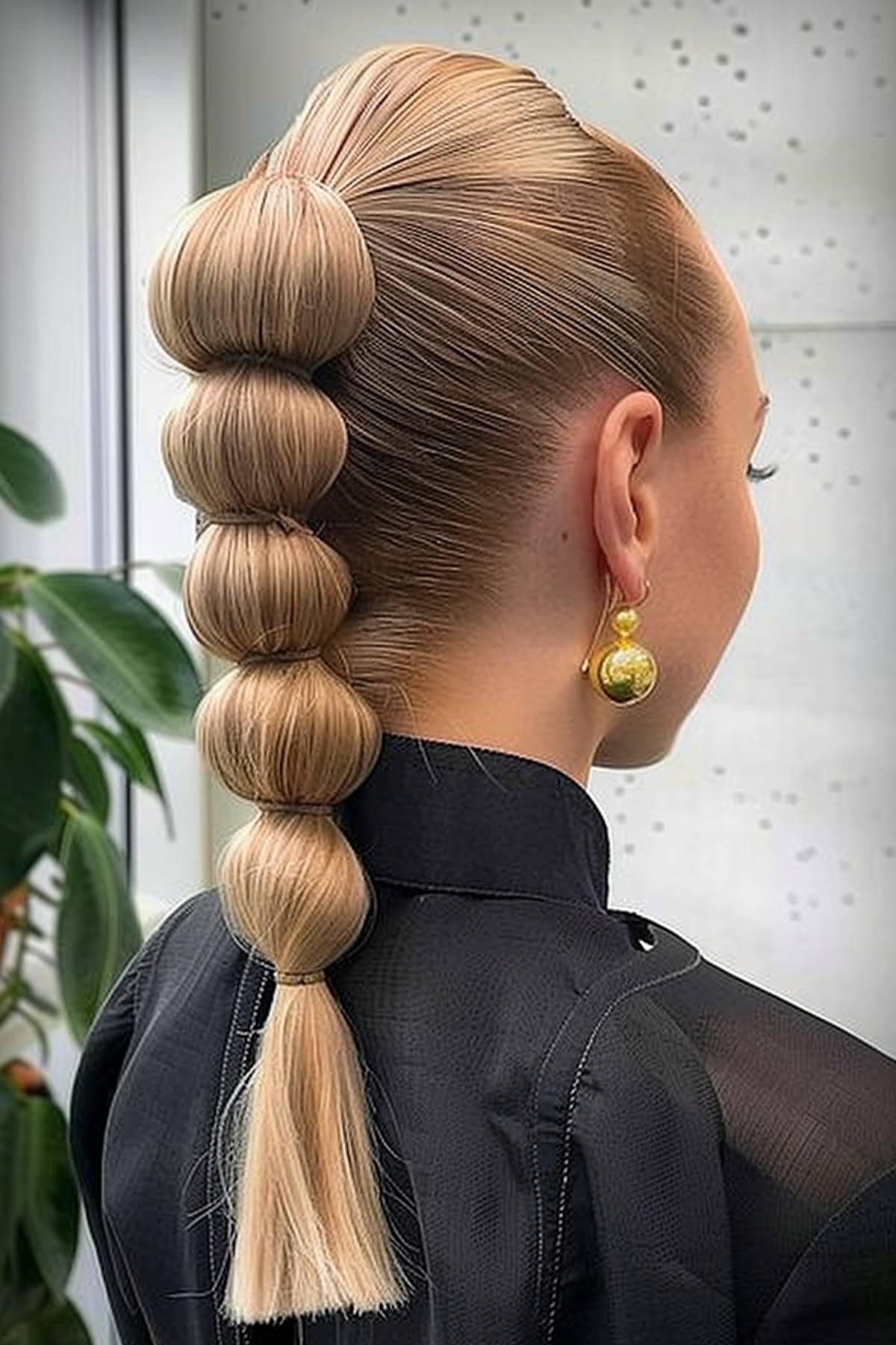 A stylish updo featuring sleek bubble braids, a perfect blend of elegance and modern texture for fine to medium hair.
