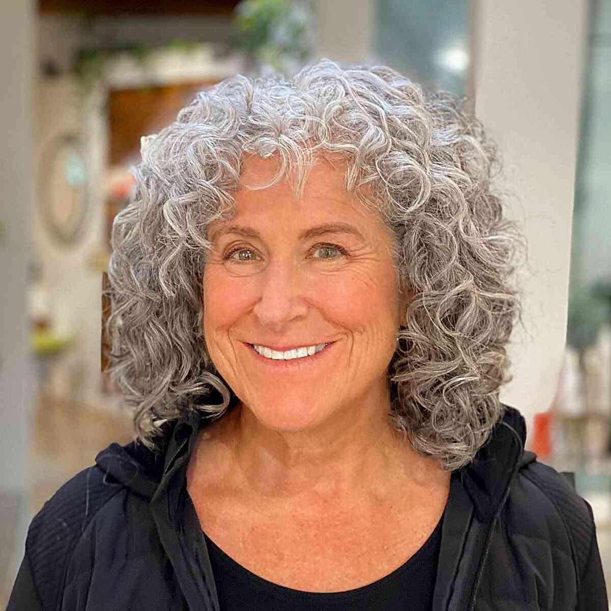 Face-Framing Layers and Fringe for older women with naturally silver curly hair