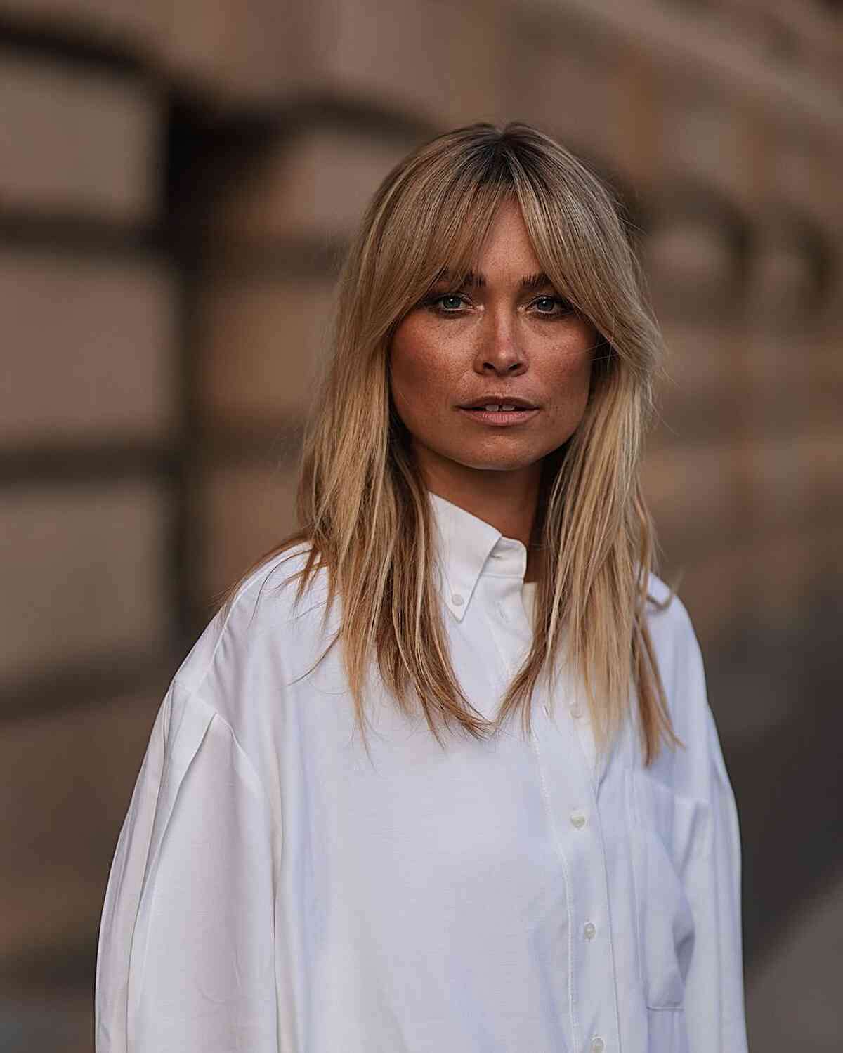 Face-Framing Medium Haircut with Wispy Layers with Curtain Bangs for Straighter Locks