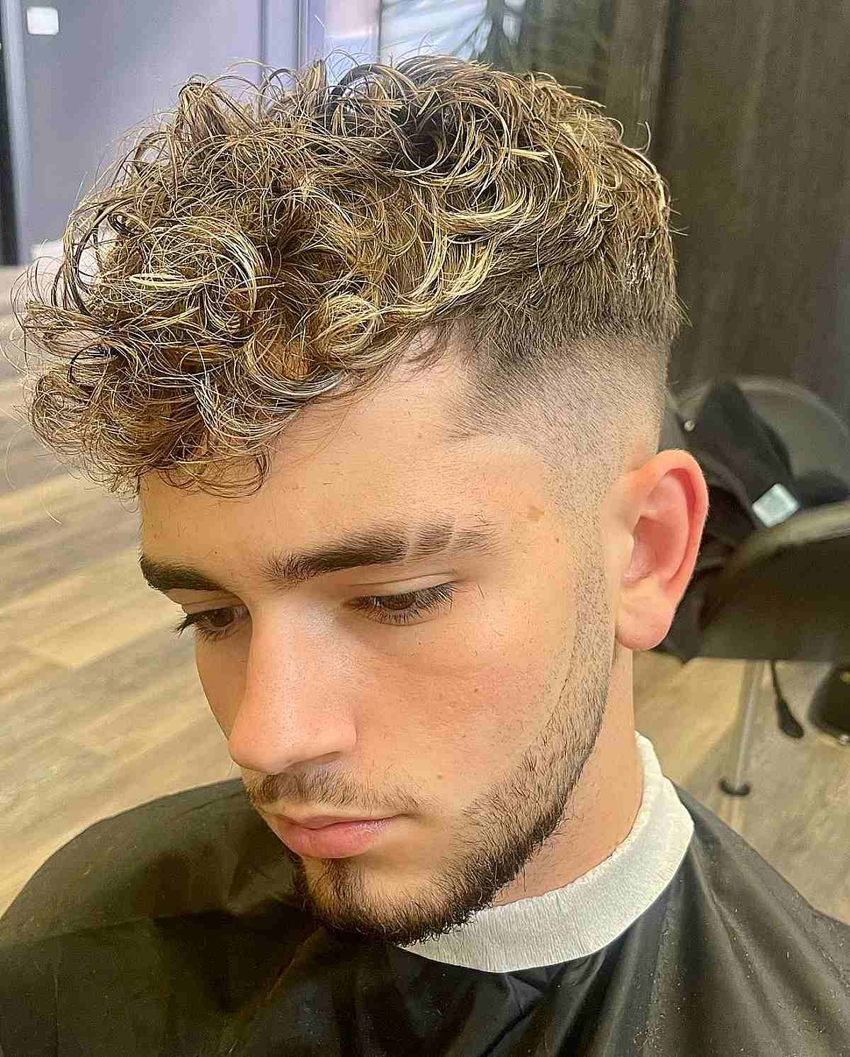 Faded Blonde Curls with Tapered Sides for Young Men