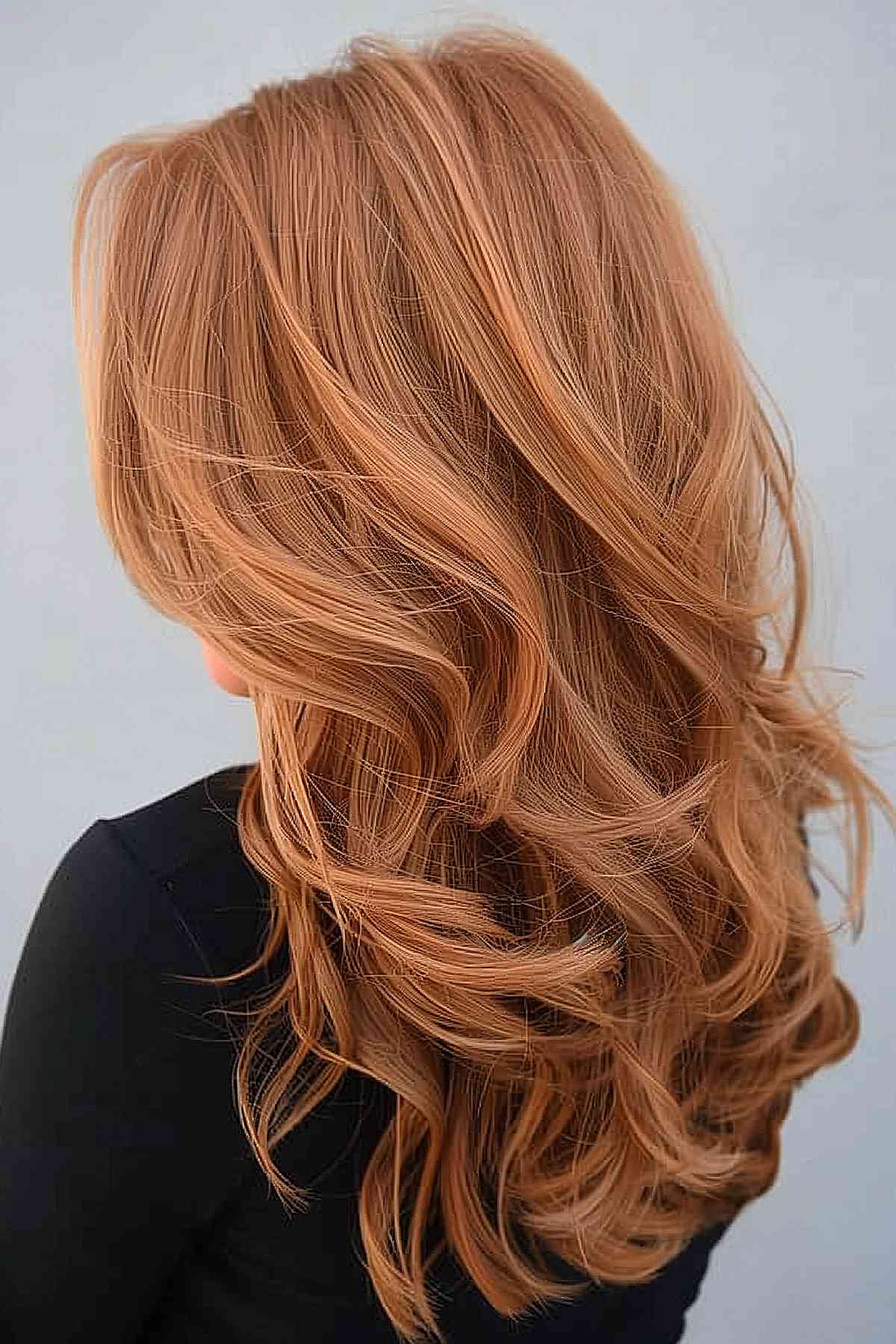 Faded ginger copper color on long wavy hair