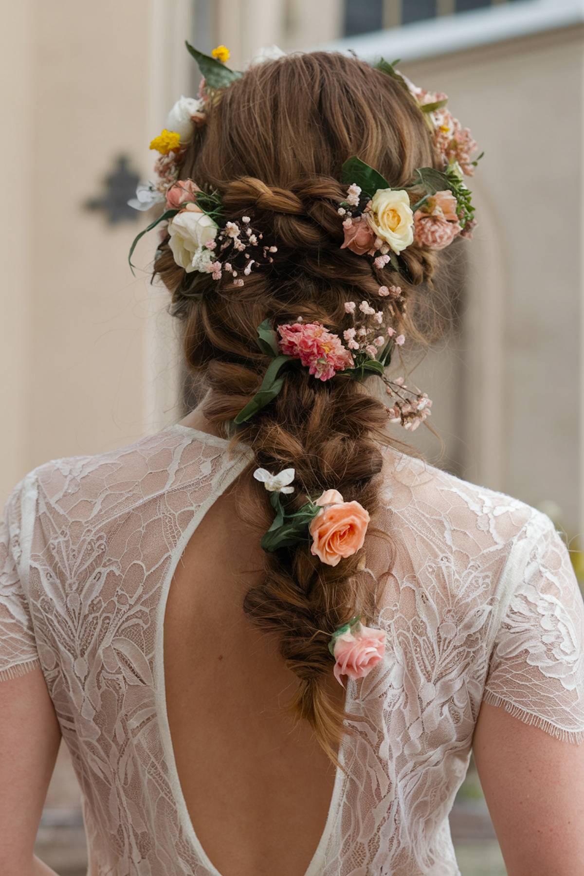 Braided wedding hairstyle with fresh flowers