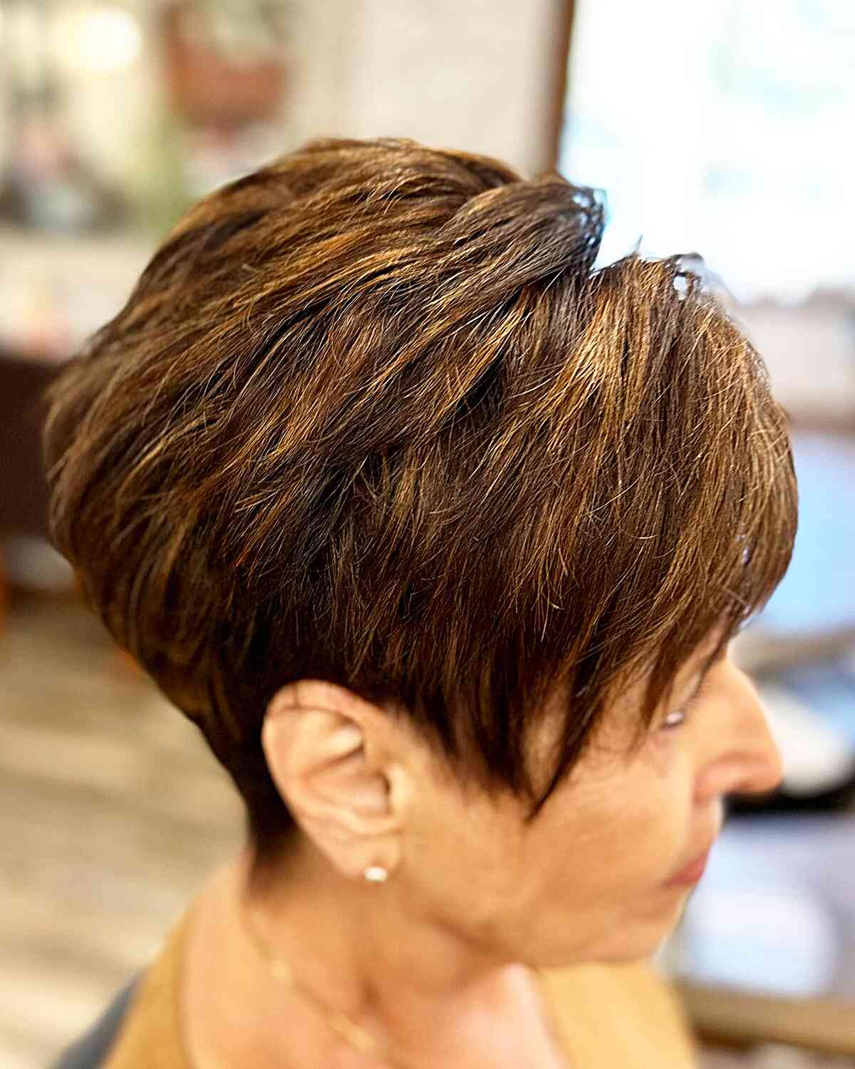 Fall Brunette Pixie with Copper Highlights on Ladies Aged 70