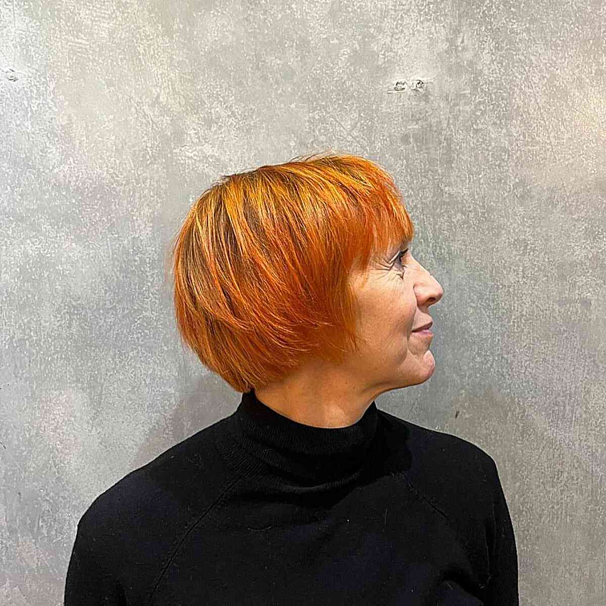 Fall-Inspired Copper Orange Bob with Bangs for Seniors over sixty