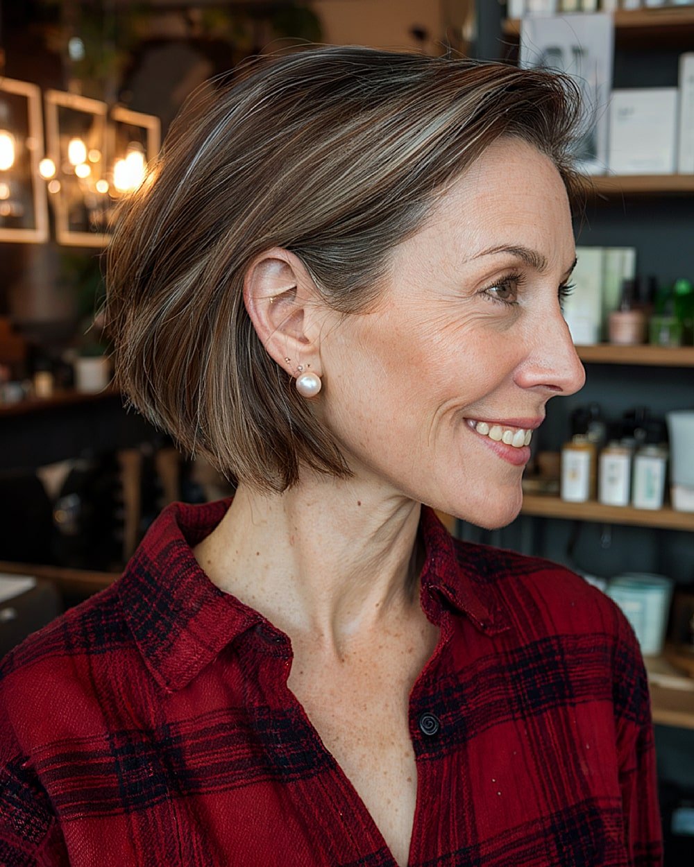 Mushroom brown chin-length bob with soft layering and tucked sides, easy low-maintenance fall haircut