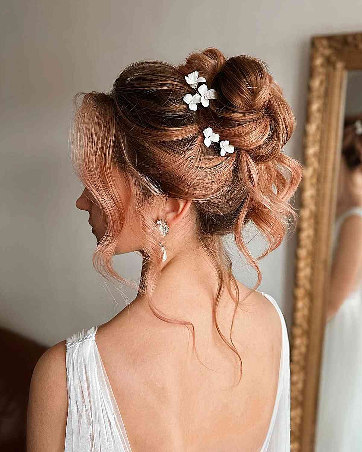 Fancy Loose Updo in a Bun with Floral Pins with Face-Framing Tendrils