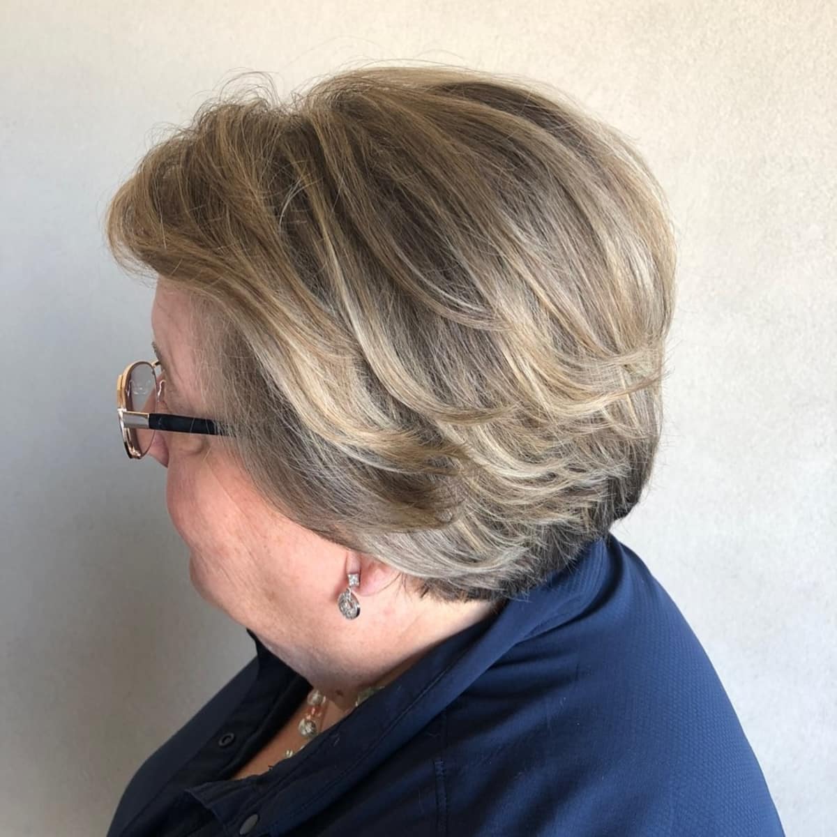 Feathered layers for women in their sixties with round face