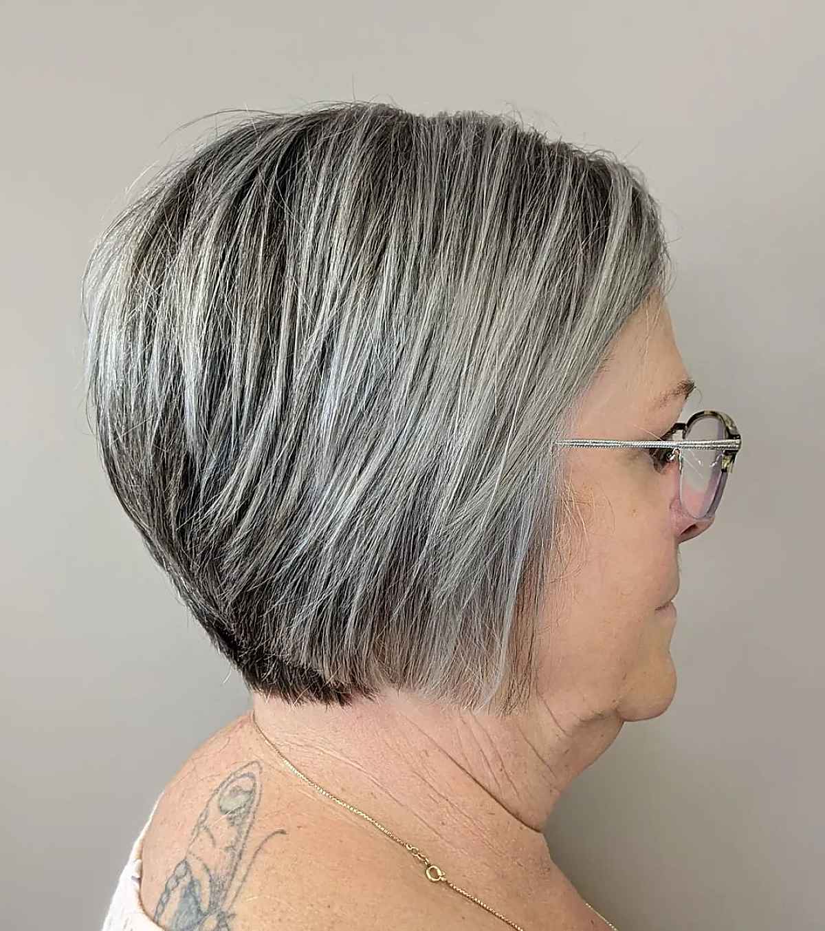 Flattering wedge hairstyle for women over 60 with glasses