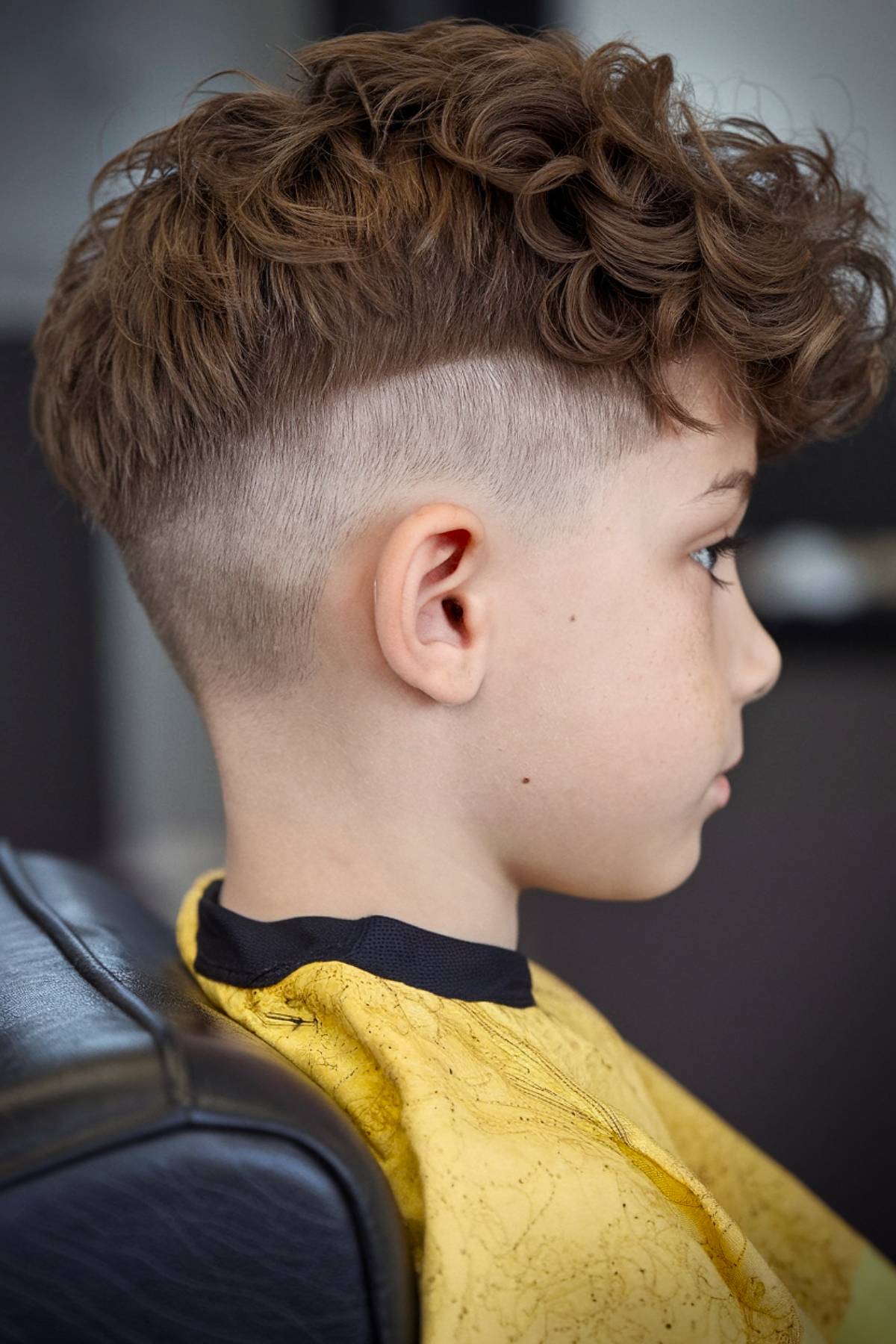 Fluffy short undercut with textured curls for boys