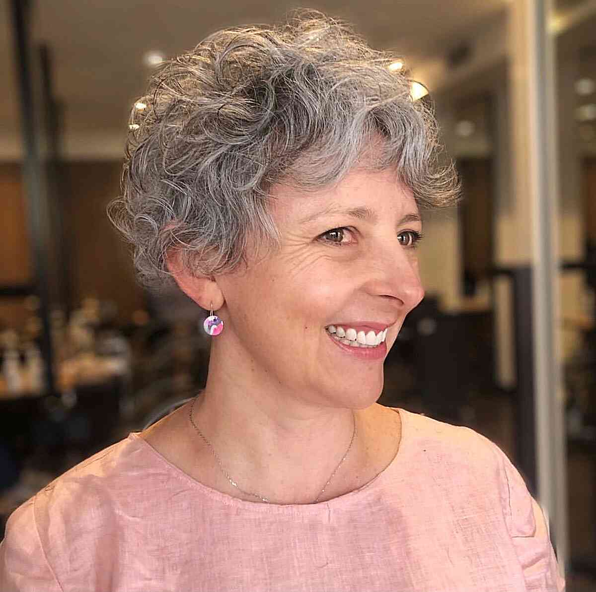 Fluffy Silver Pixie on Natural Curls with Short Curtain Bangs for Ladies Over 50