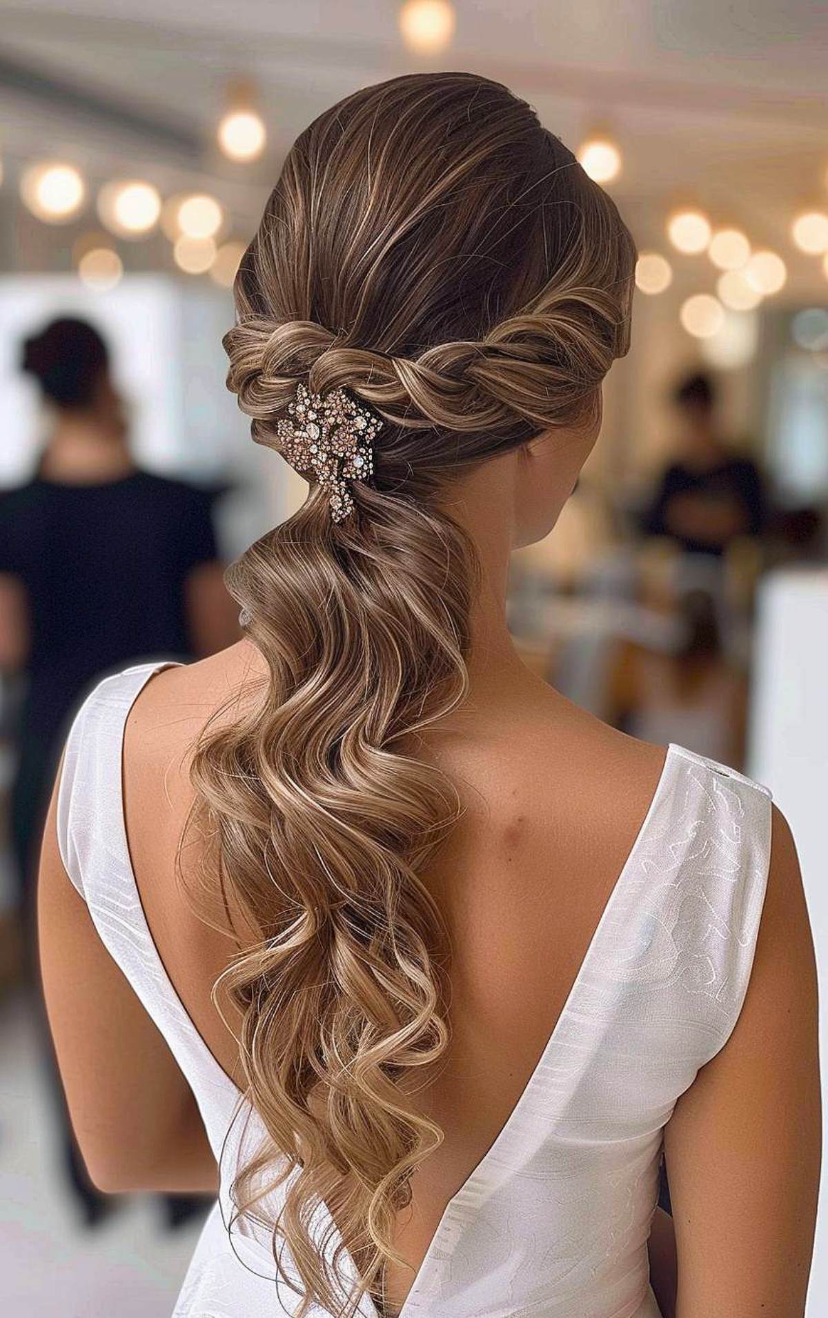 Formal curly ponytail hairstyle with twisted sides and hair accessory