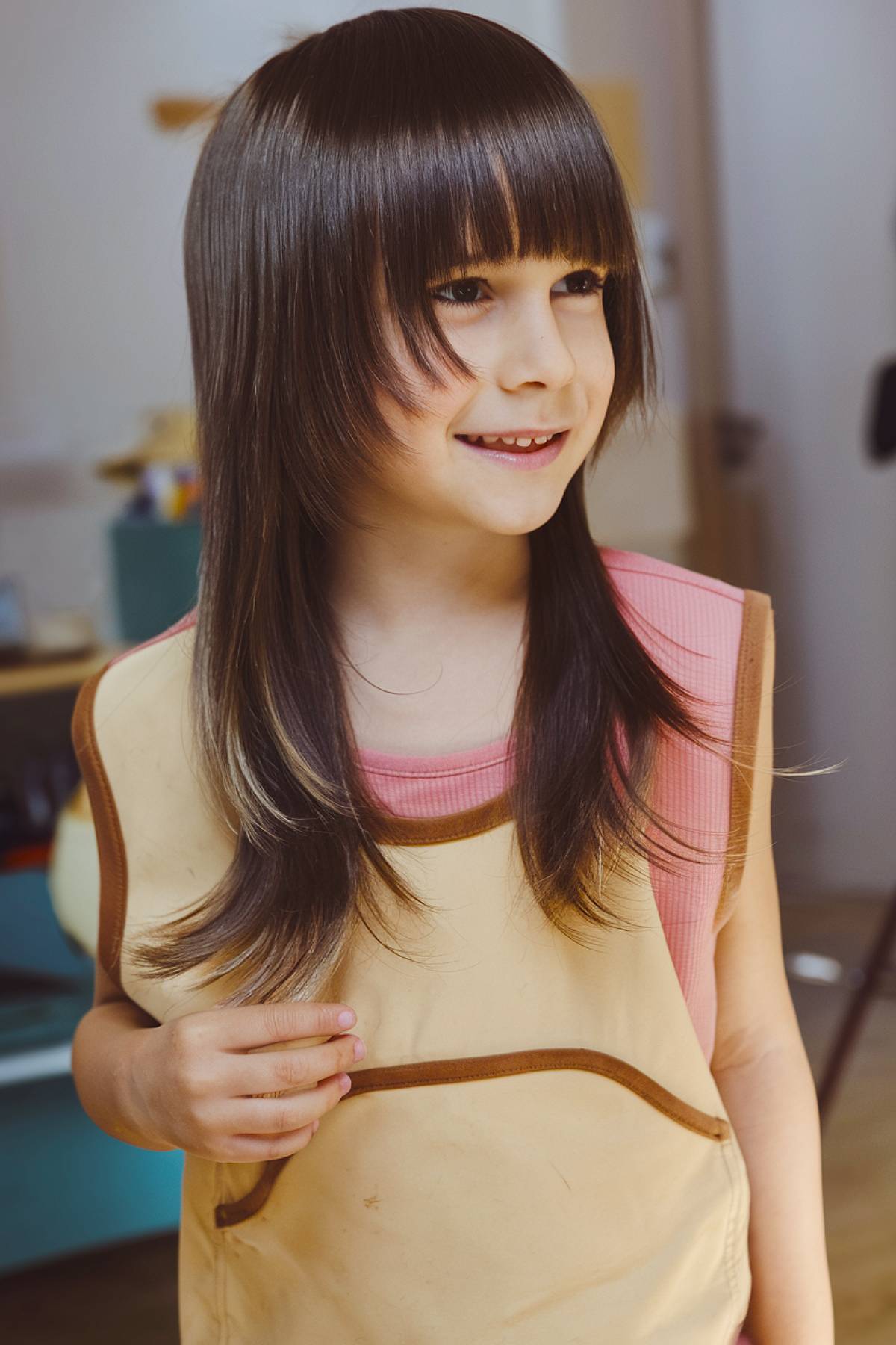 Long layered emo haircut for kids with straight bangs and soft feathered ends