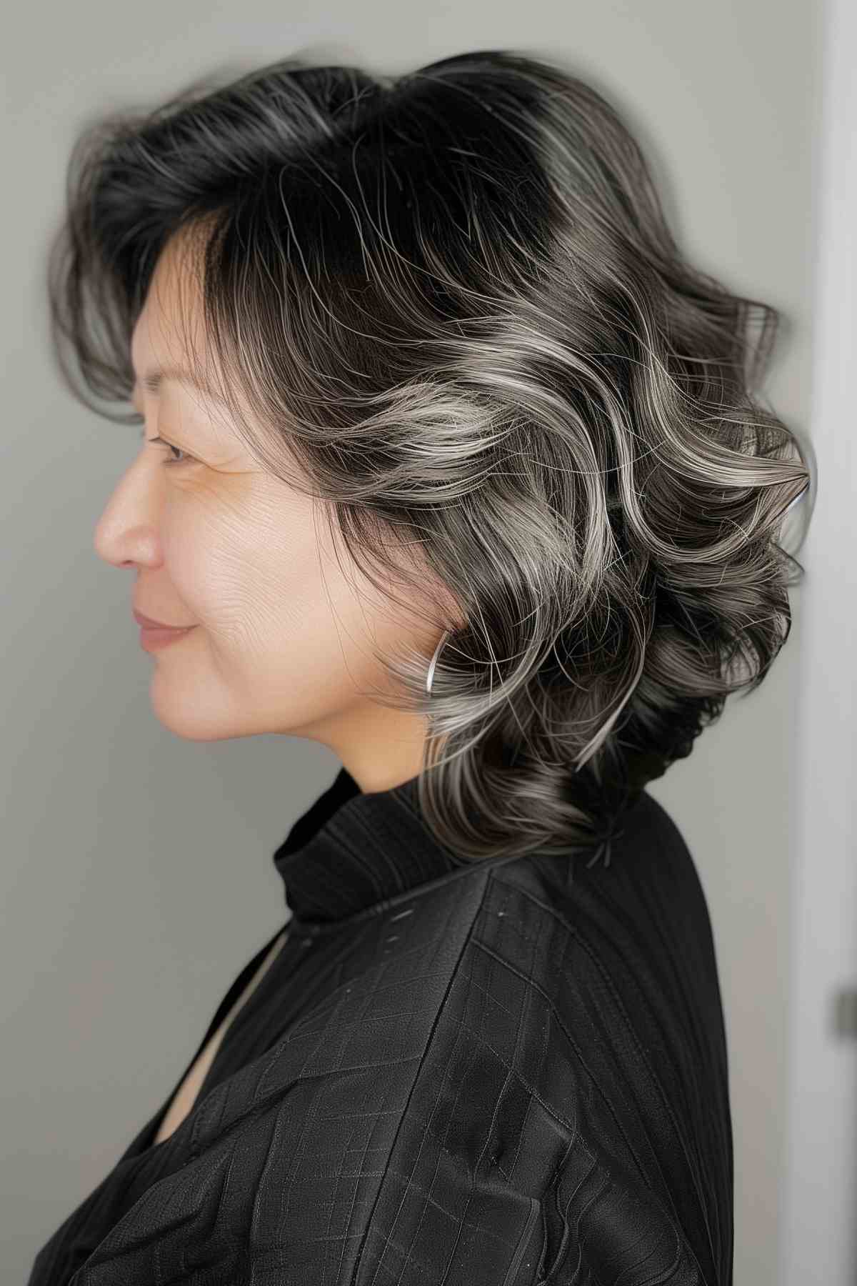 Shoulder-length wavy hair with silver highlights, ideal for older women with medium to thick hair