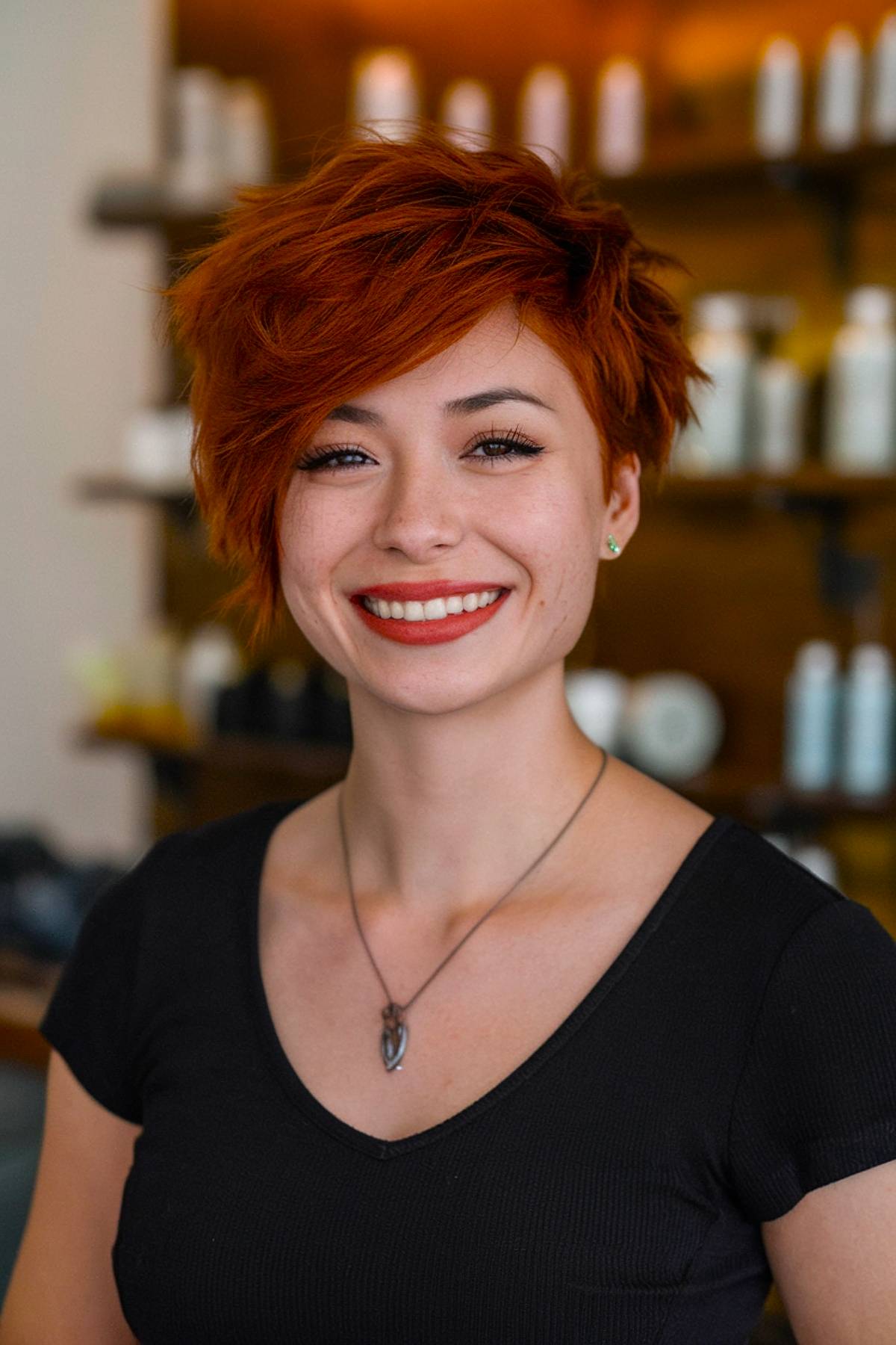 Bold red asymmetrical pixie cut with textured layers for an edgy, dynamic style