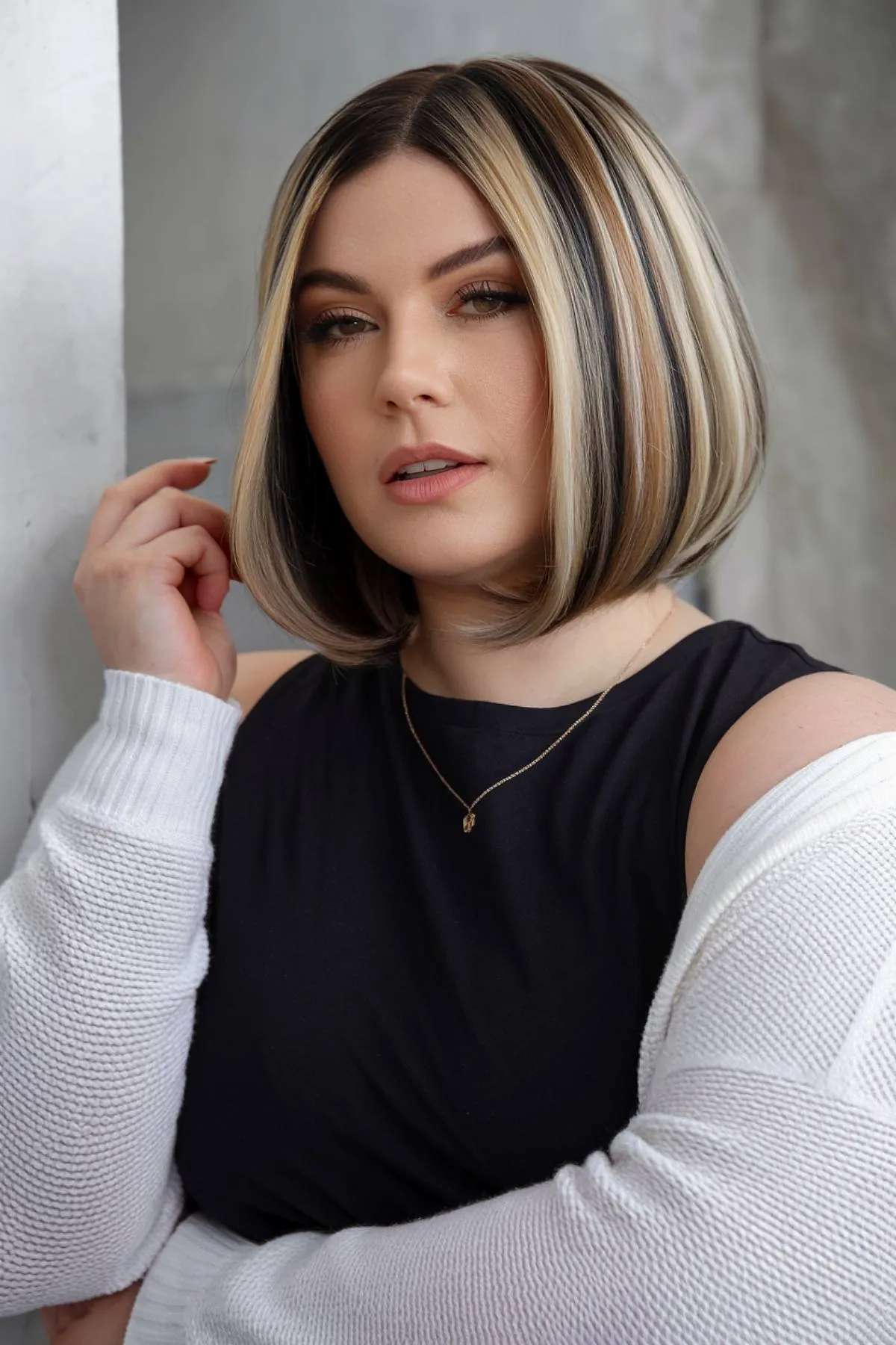 A-line bob haircut with bold highlights for plus size women