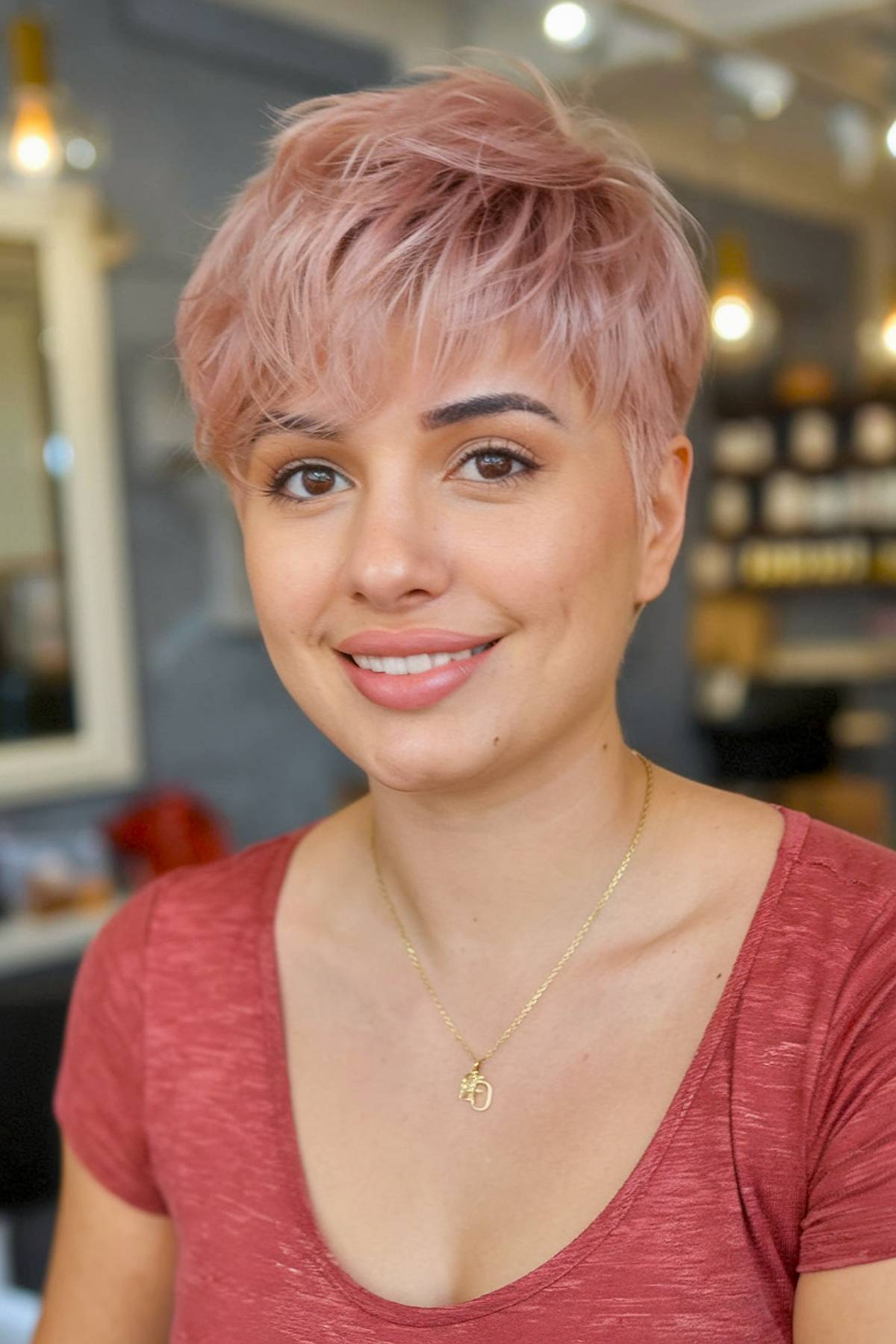 Tousled rose gold pixie cut with textured layers for thick hair