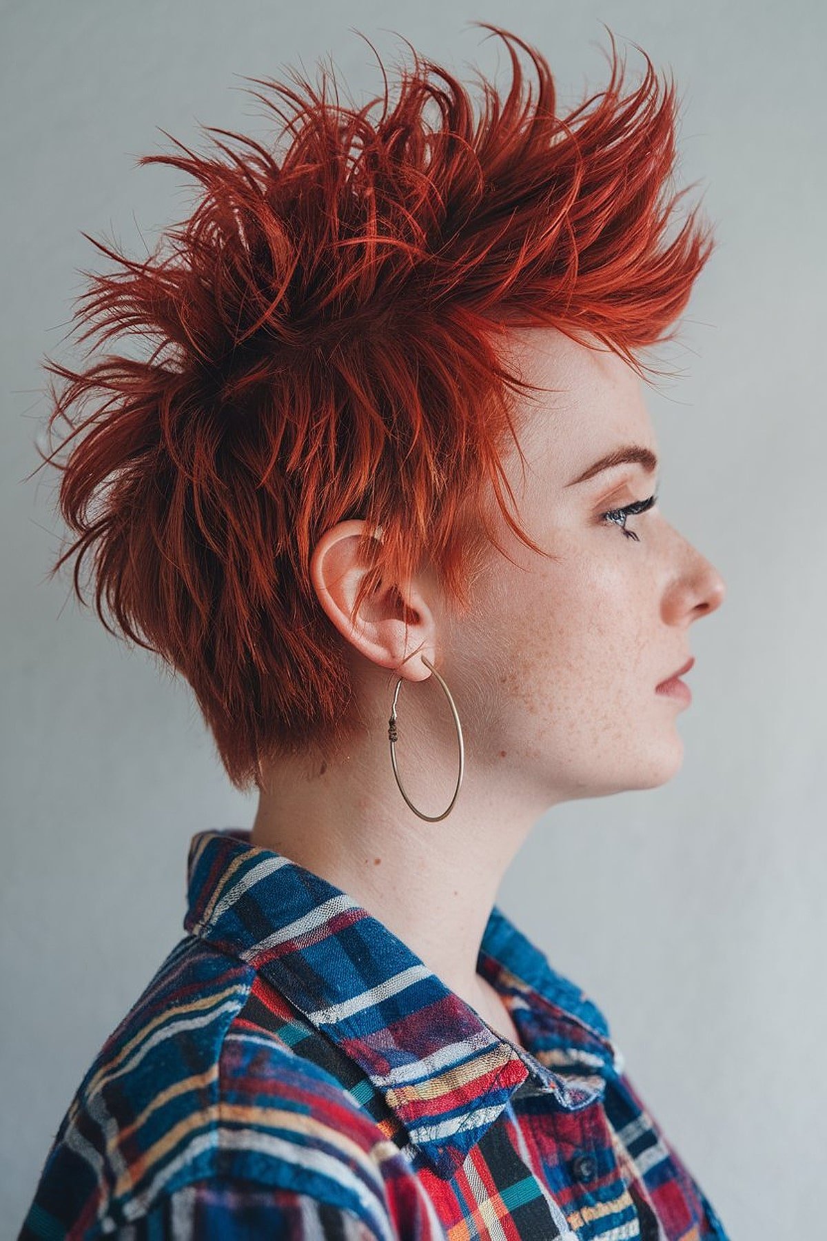 Funky red pixie cut with a bold mohawk style