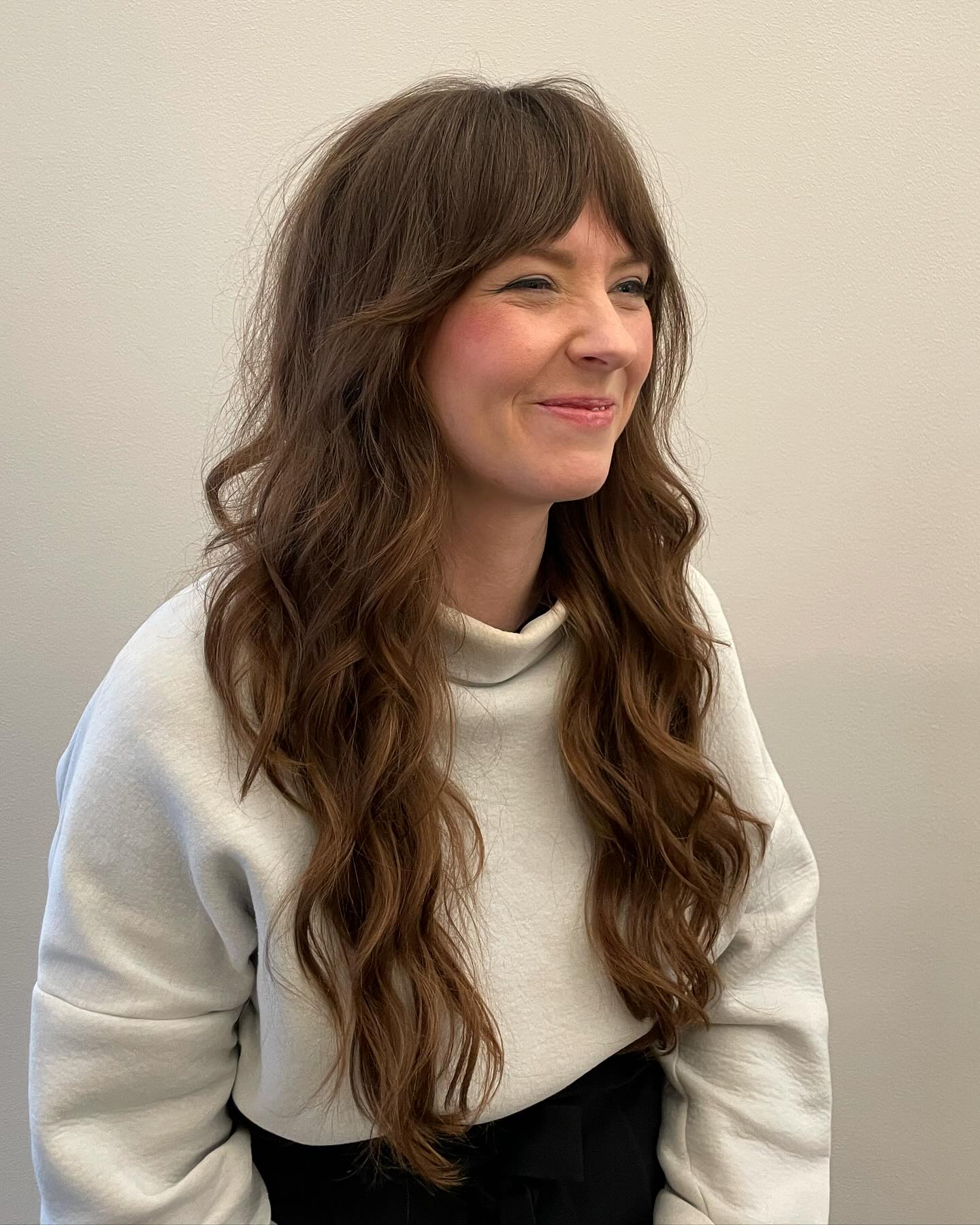 Textured Chestnut Waves with Elegant Curtain Bangs