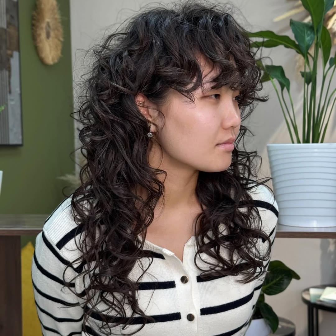 Flowing Chestnut Curls with Soft Side-Swept Bangs