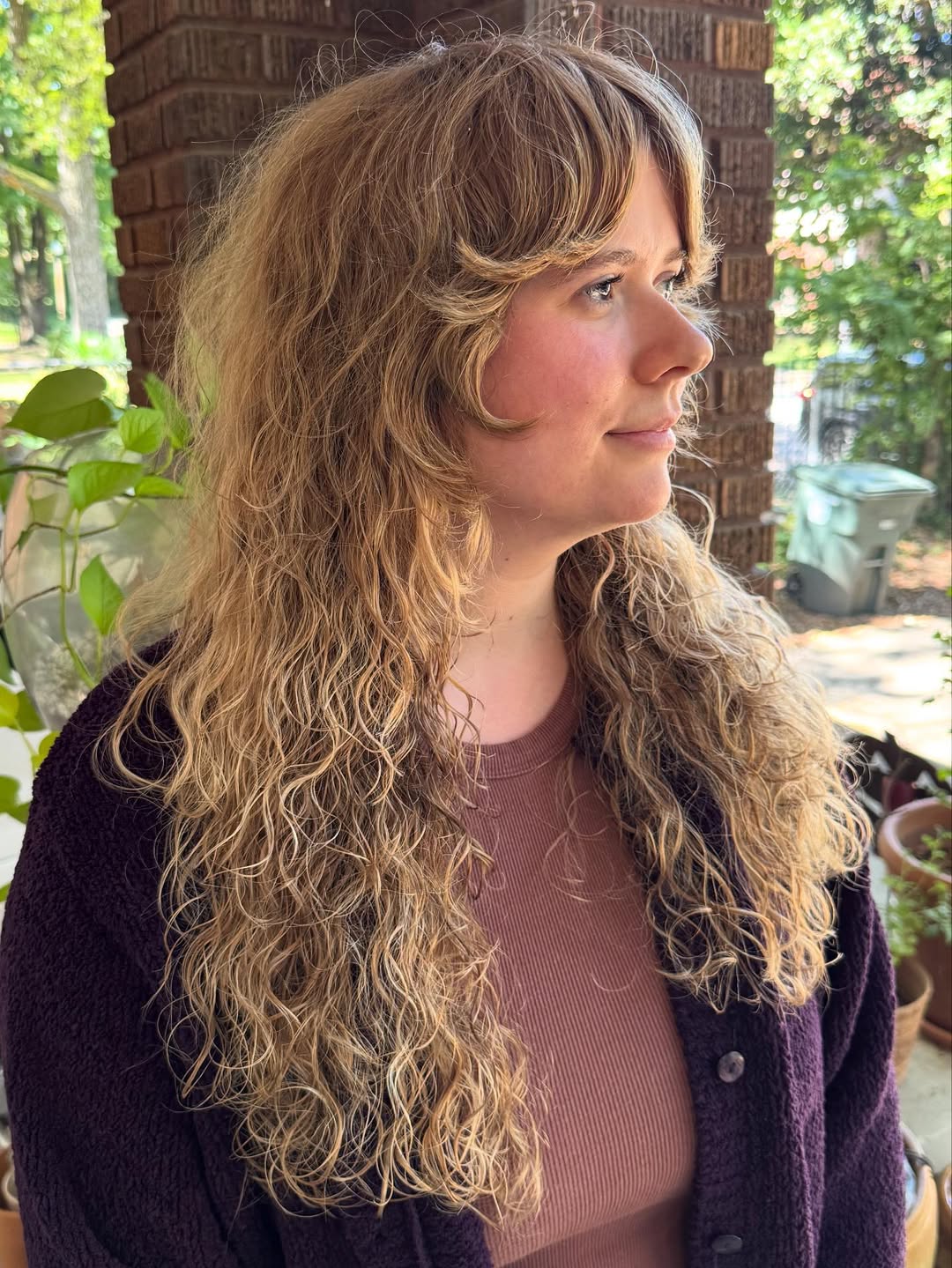 Golden-Caramel Curly Cascade with Face-Framing Bangs