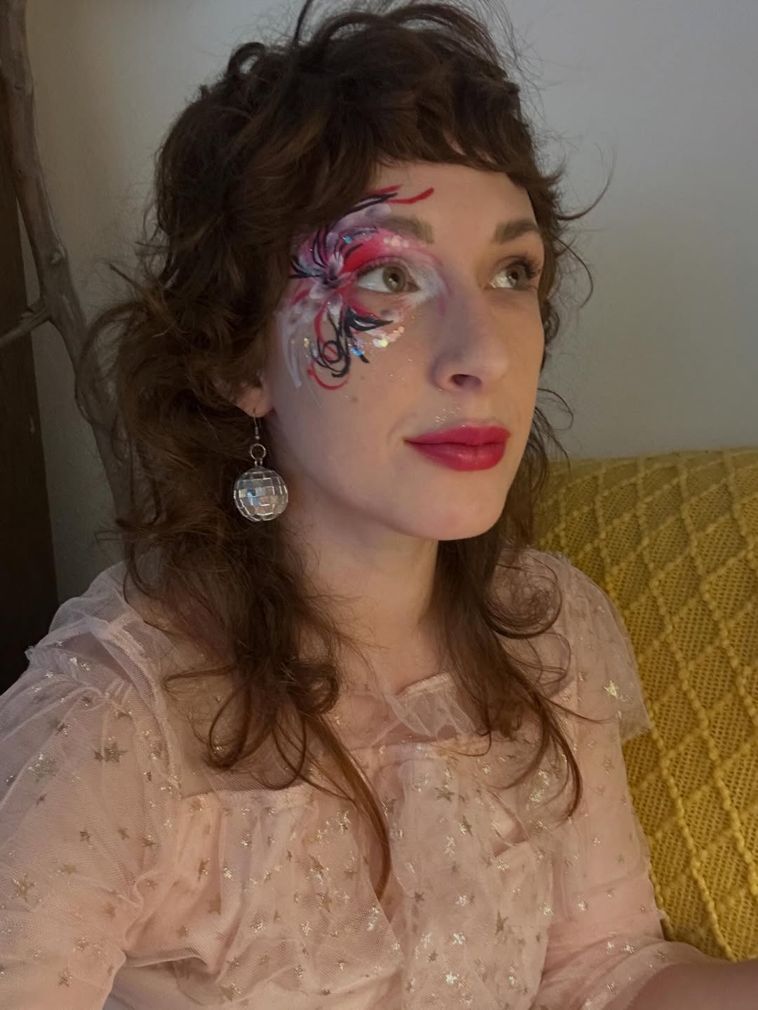 Whimsical Rosewood Curls with Artistic Face Paint