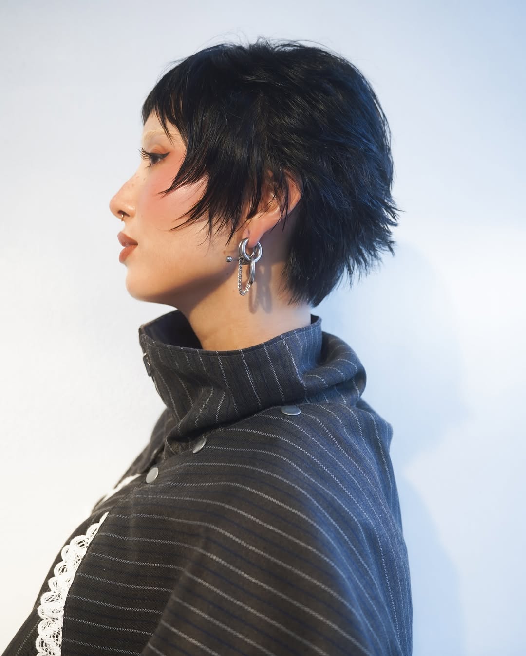 Edgy Black Textured Layered Bob with Earring Accent
