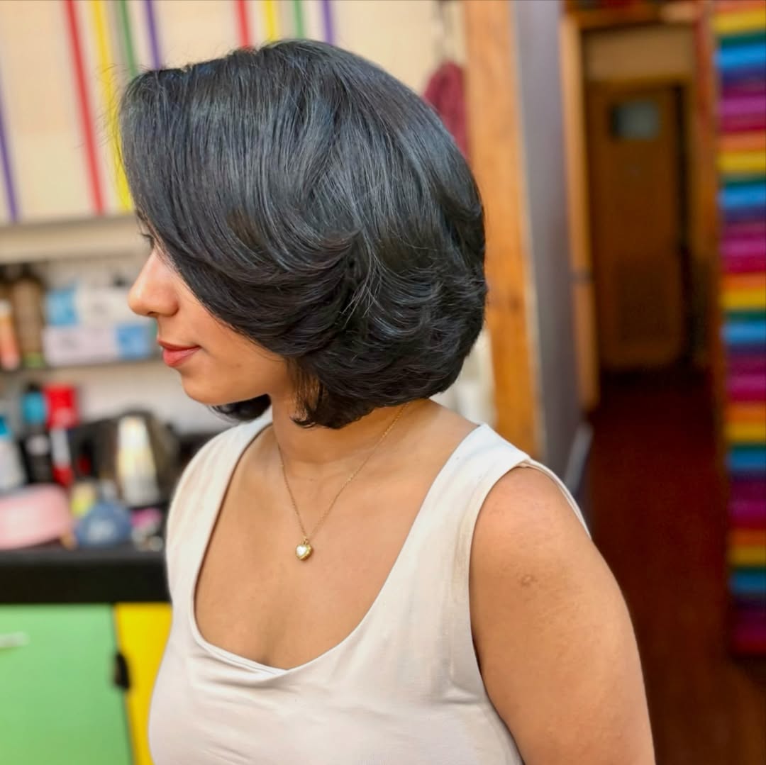 Jet-Black Layered Bob with Side-Swept Bangs