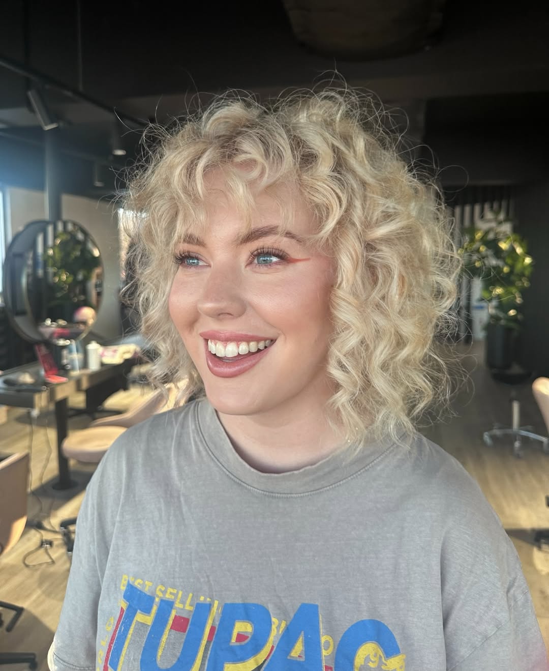 Sun-Kissed Blonde Curly Lob with Bright Highlights