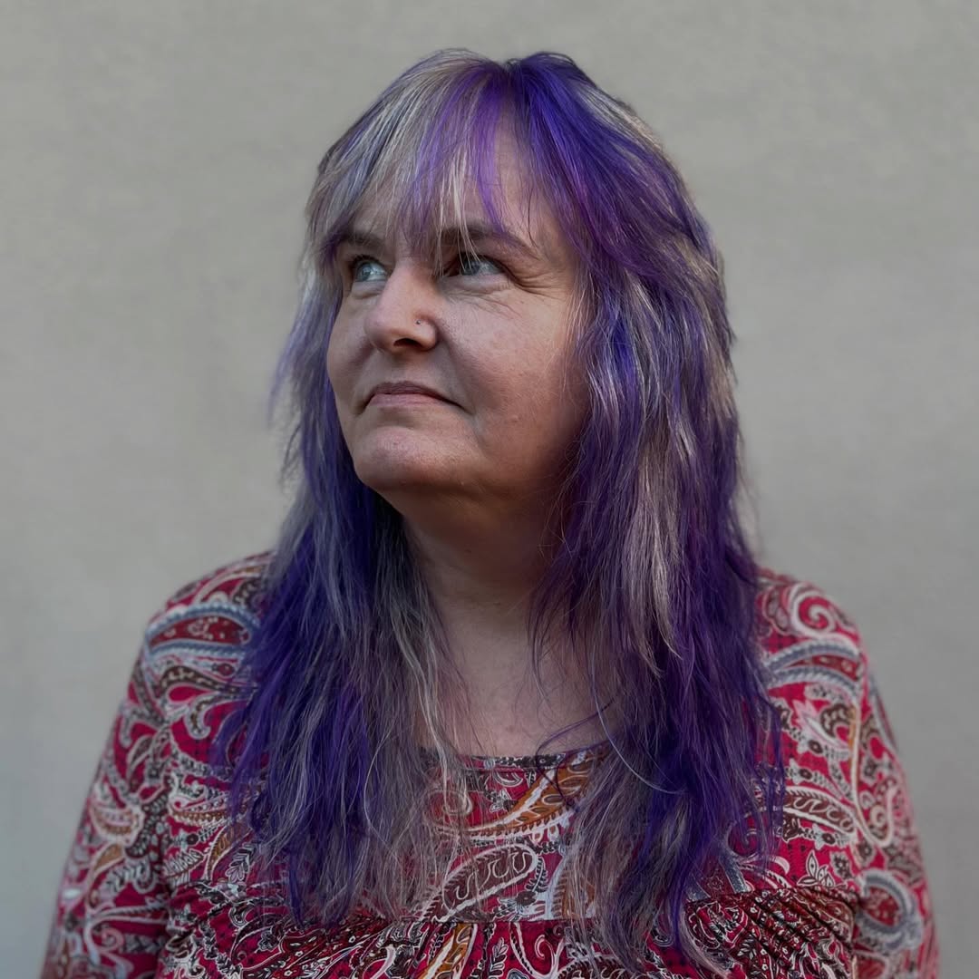 Violet-Infused Silver Streaks for Textured Medium-Length Hair