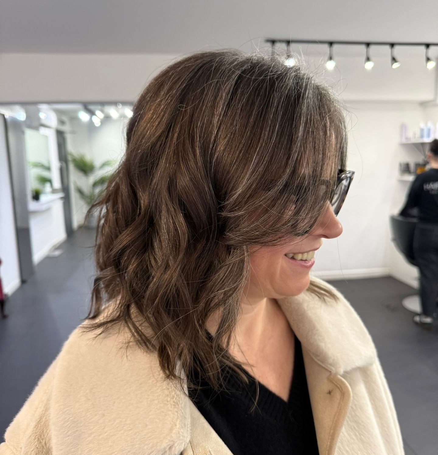 Softly Tousled Chestnut Waves with Side-Swept Bangs