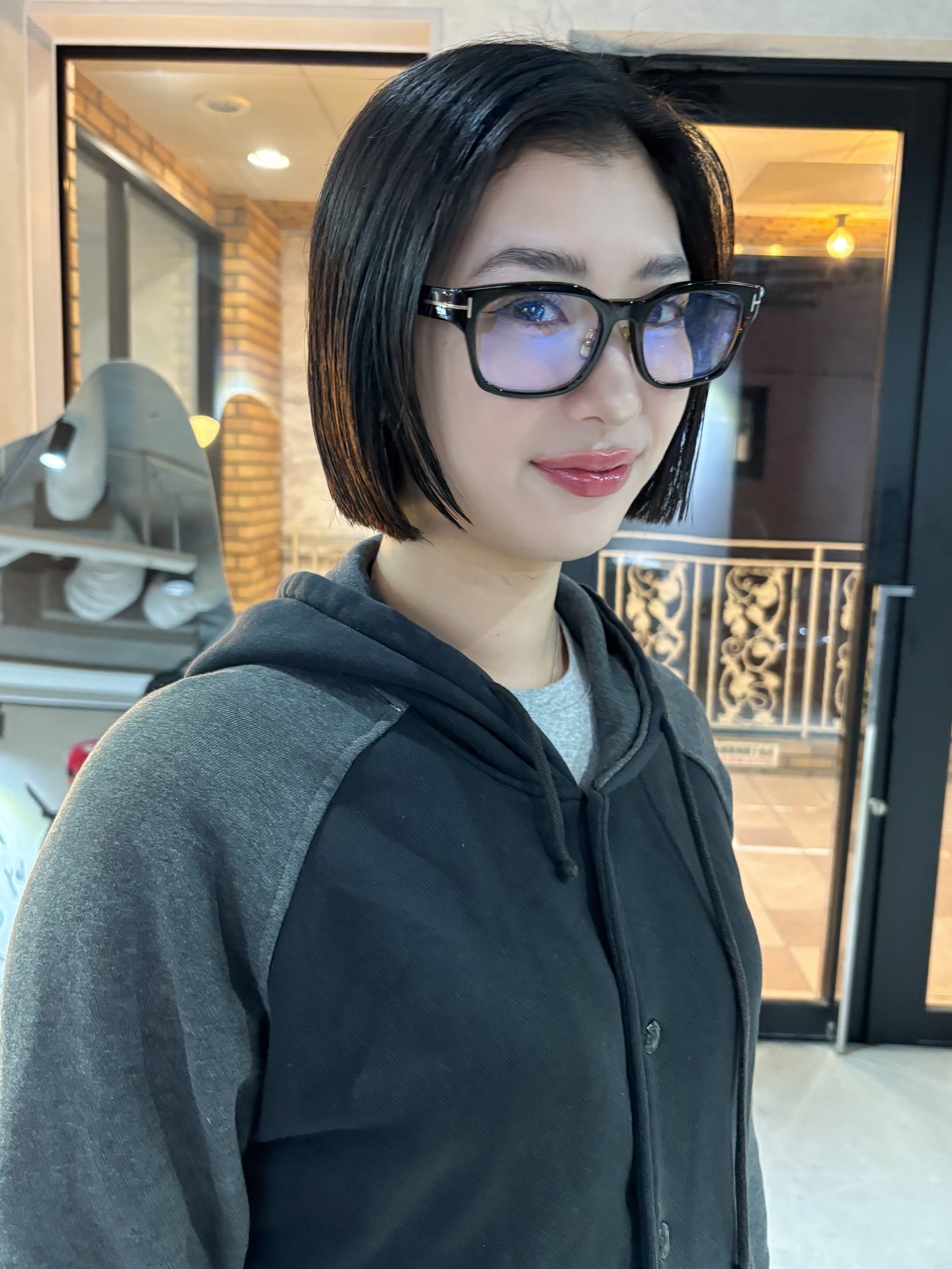 Glossy Onyx Angled Bob with Blue-Black Undertones