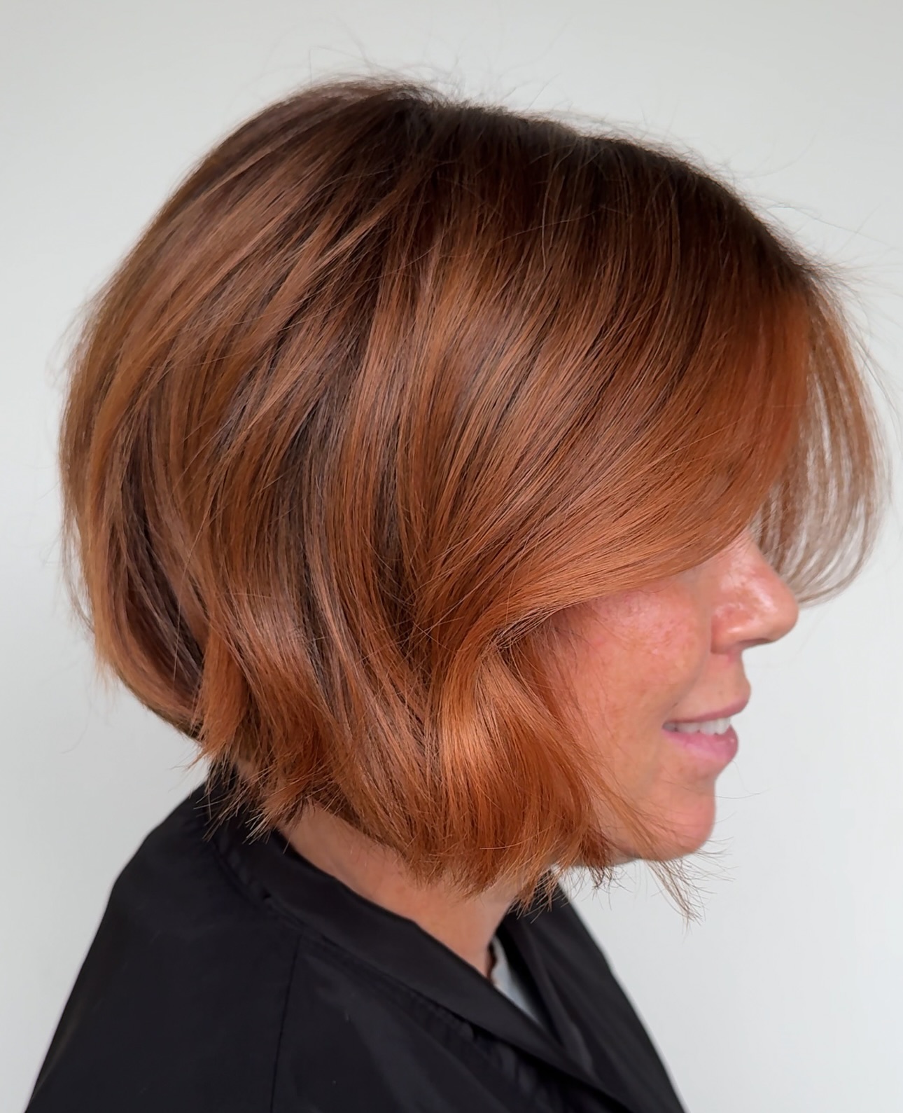 Vibrant Copper Layered Bob with Side Swept Fringe