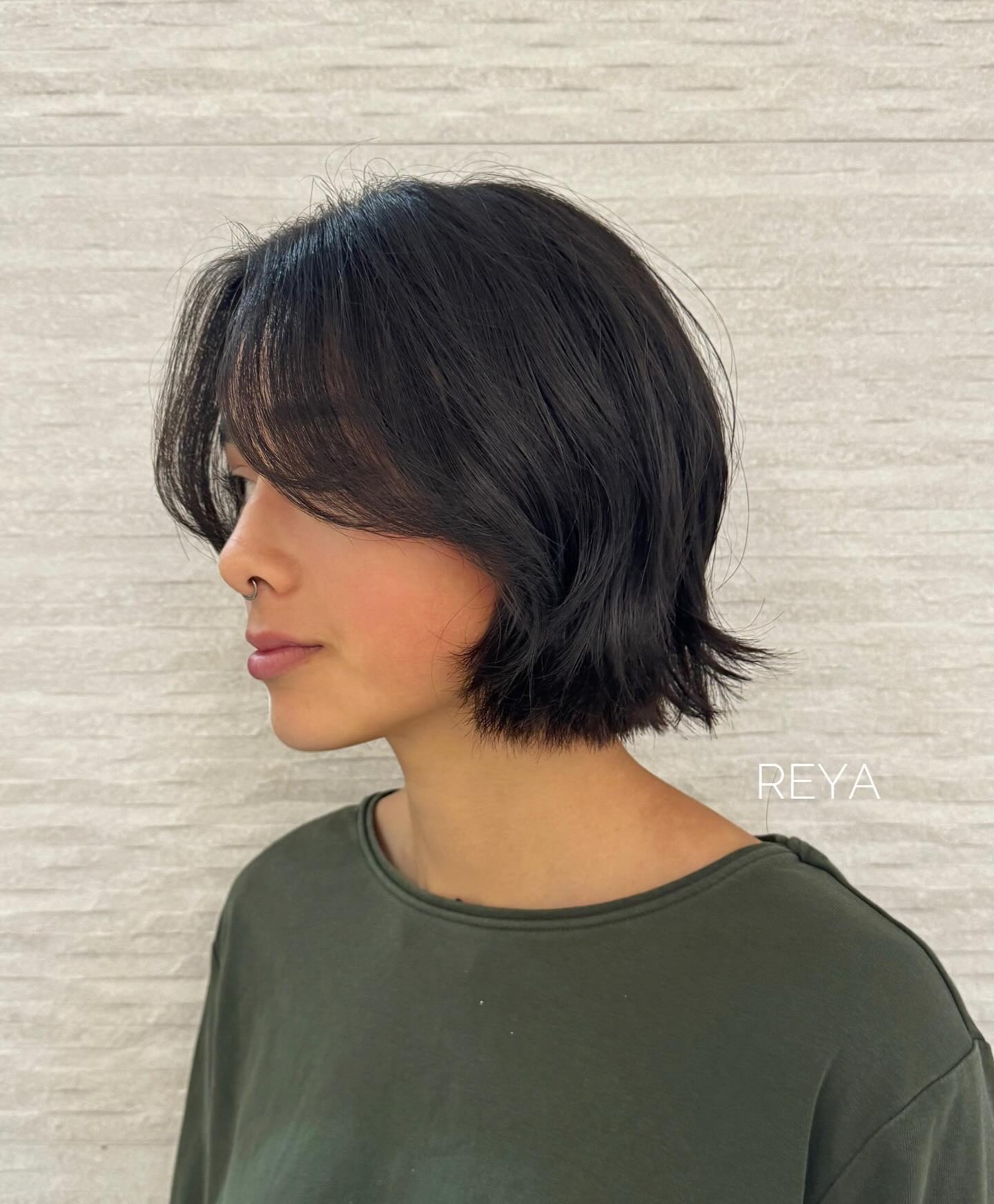 Effortless Jet-Black Textured Chin-Length Bob with Side-Swept Bangs