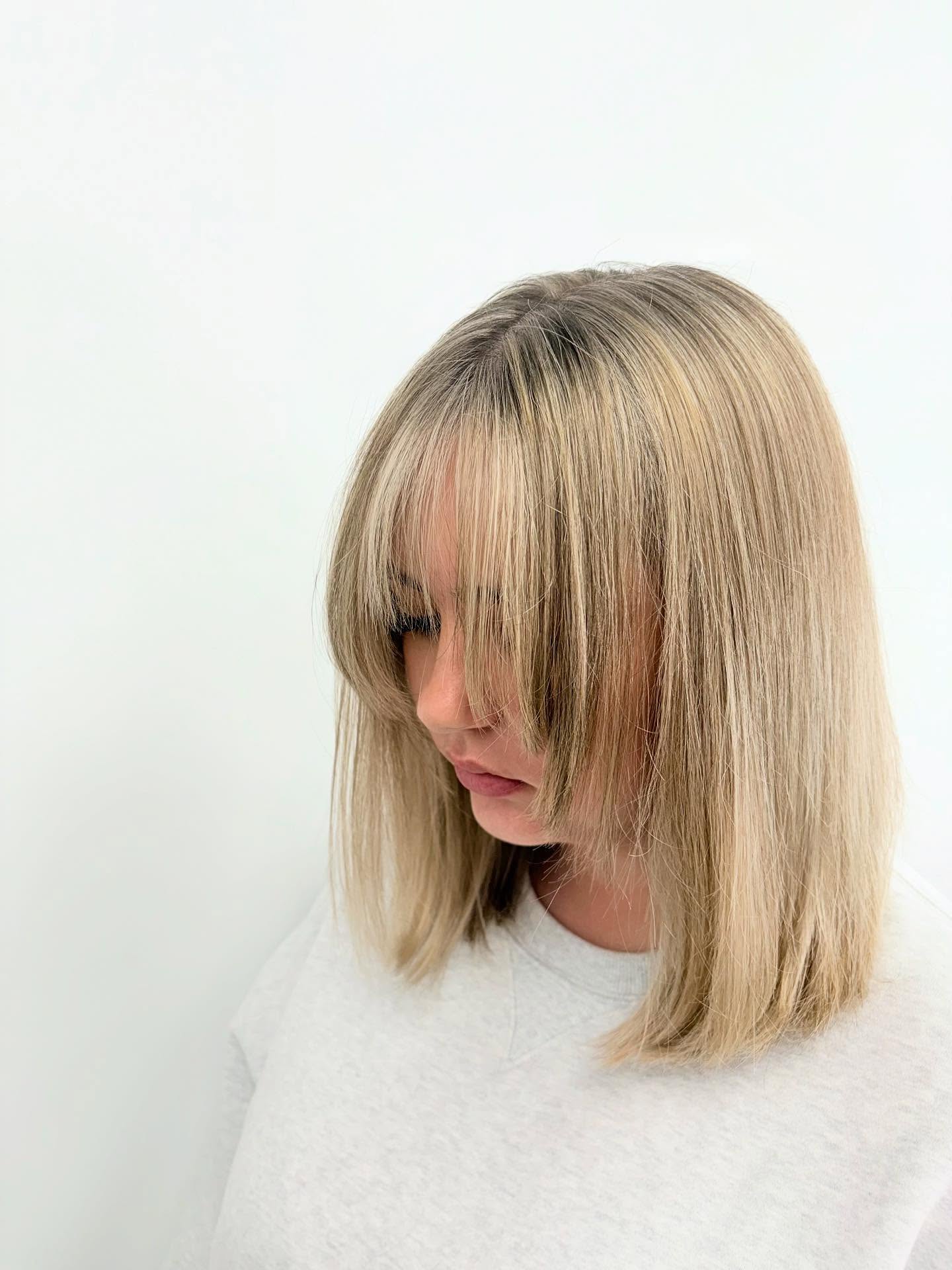 Ashy Blonde Blunt Lob with Wispy Curtain Fringe and Subtle Root Melt