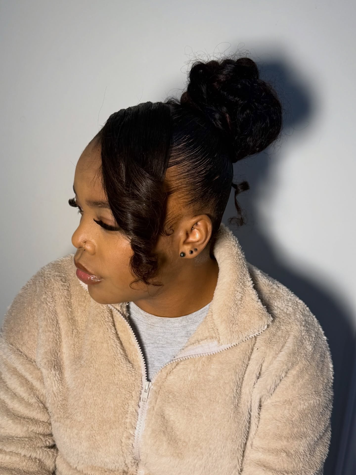 Sleek High Textured Bun with Sculpted S-Curl Fringe