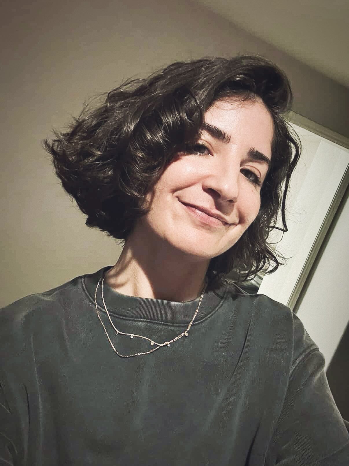 Voluminous Short Curly Bob with Deep Side Sweep and Flicked Ends