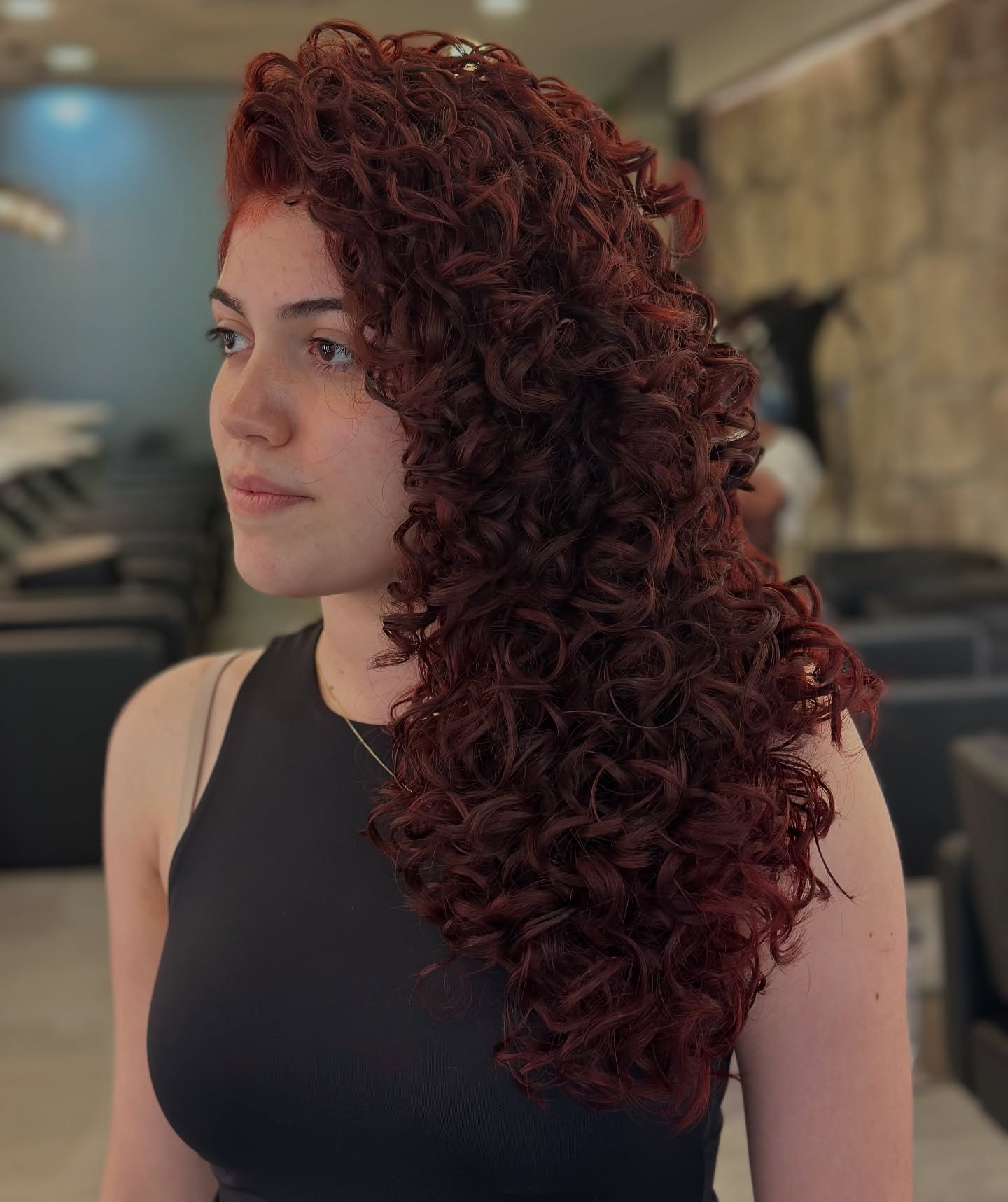 Dynamic Long Curly Layers with Rich Burgundy Tones