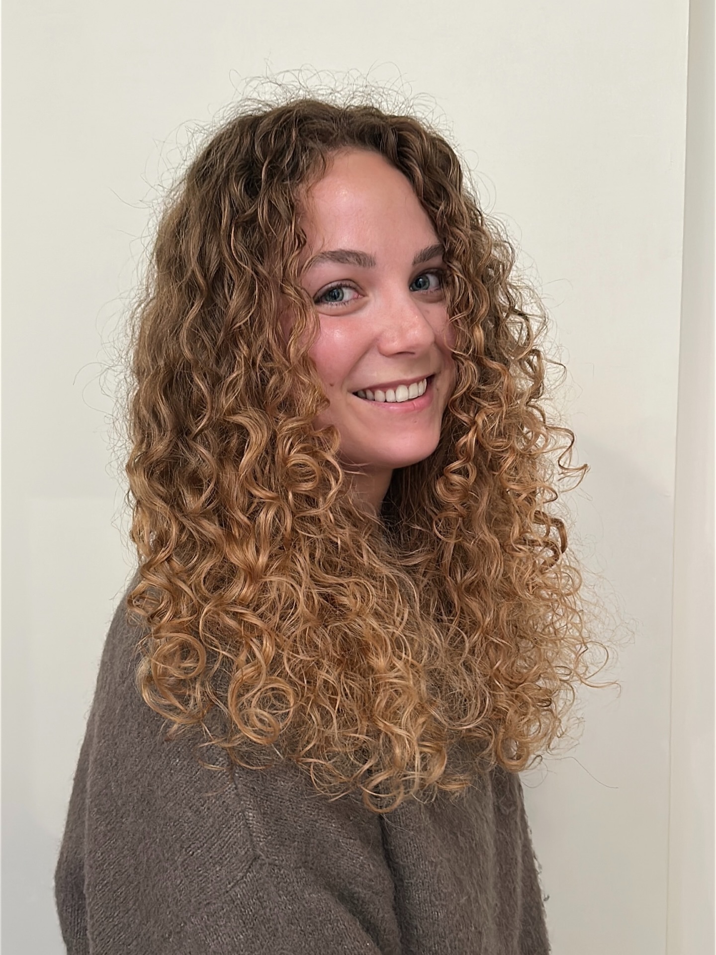 Long Layered Chest-Length Corkscrew Curls with Natural Balayage