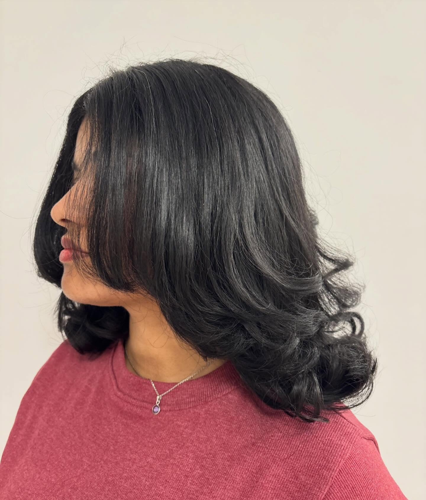 Glossy Layered Shoulder-Length Blowout with Face-Framing Swoops