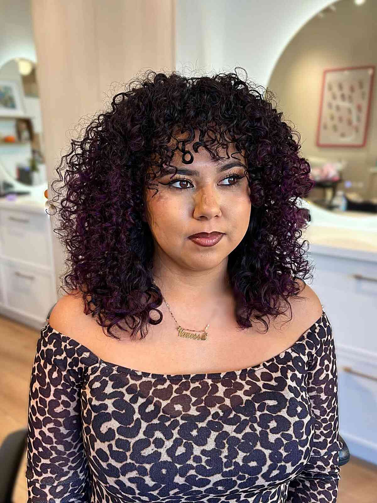 Vibrant Curly Layers with Rich Purple Highlights