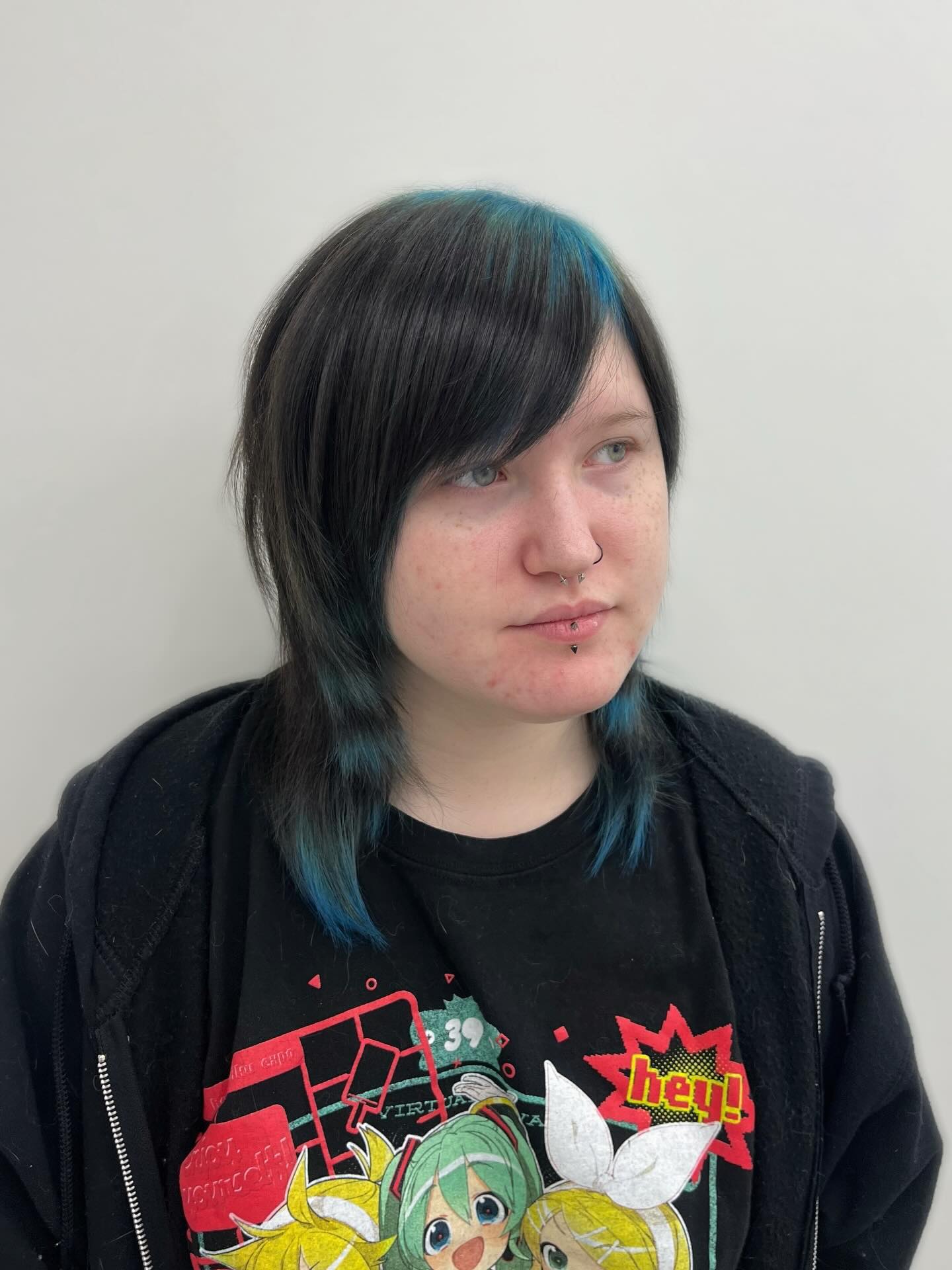Bold Asymmetrical Cut with Vibrant Blue Highlights
