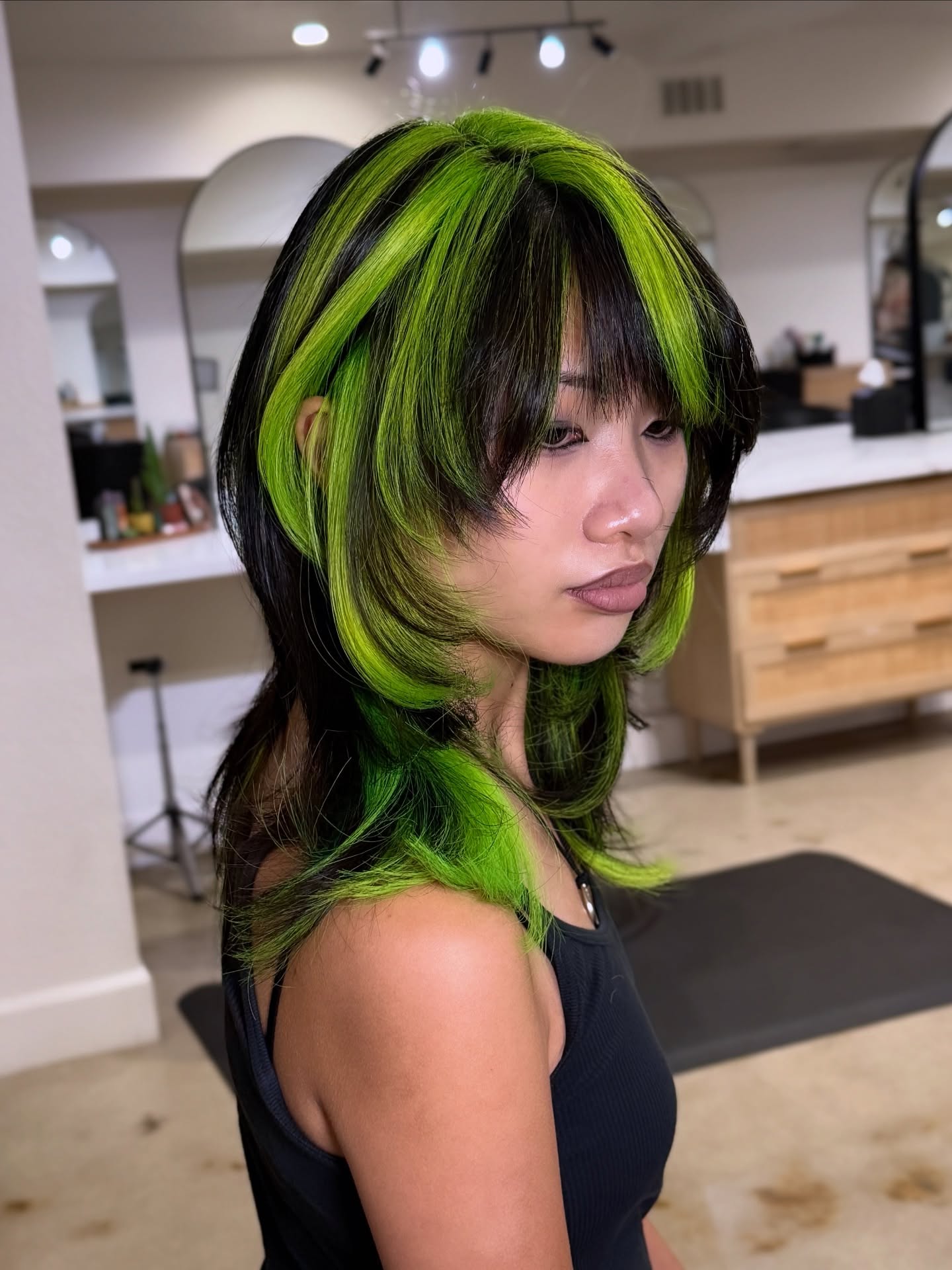 Edgy Black and Neon Green Layered Cut with Textured Bangs