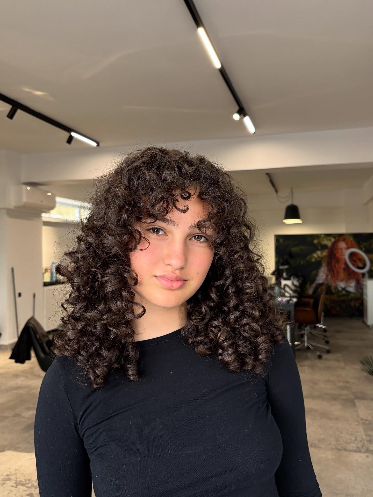 Charming Curly Medium Cut with Soft Fringe