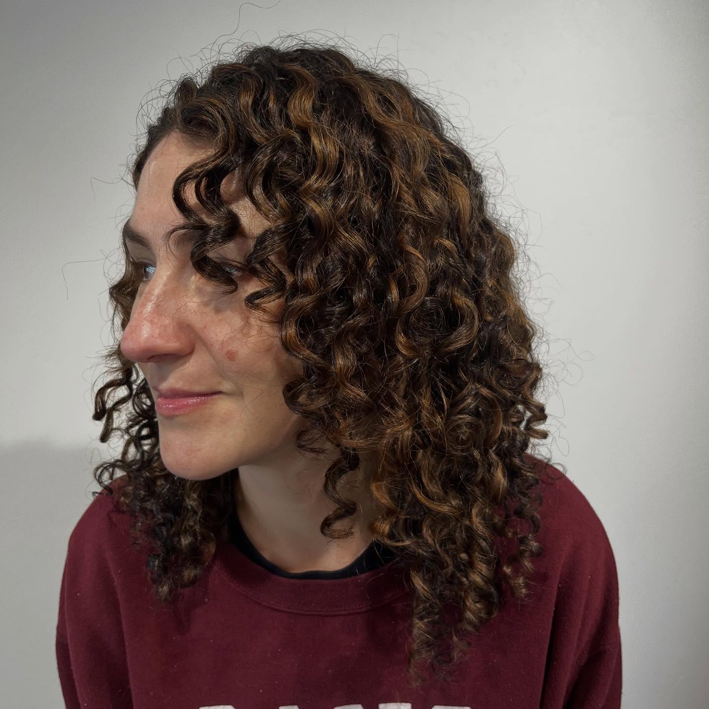 Dynamic Curly Medium Cut with Defined Layers