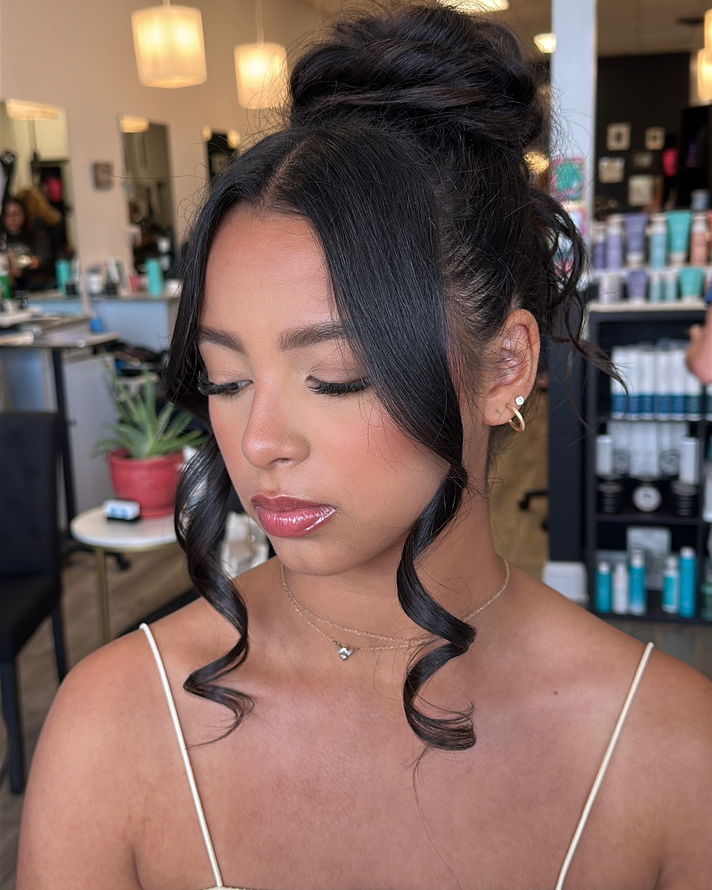 Chic High Bun with Loose Face-Framing Curls