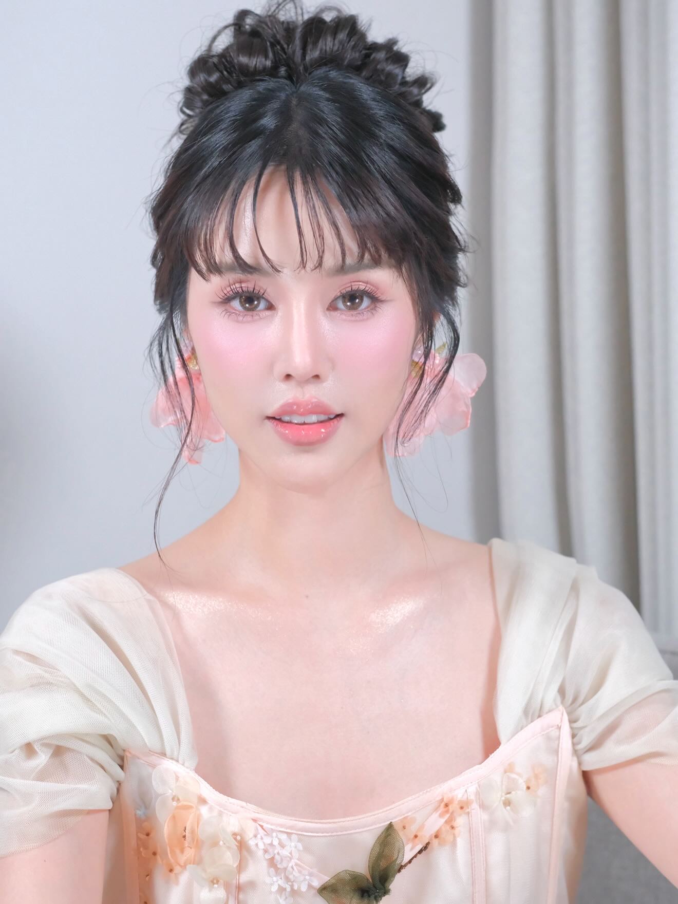 Elegant Textured Updo with Face-Framing Bangs
