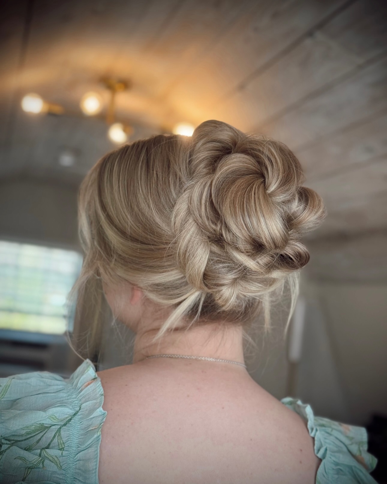 Elegant Twisted Low Bun with Soft Waves