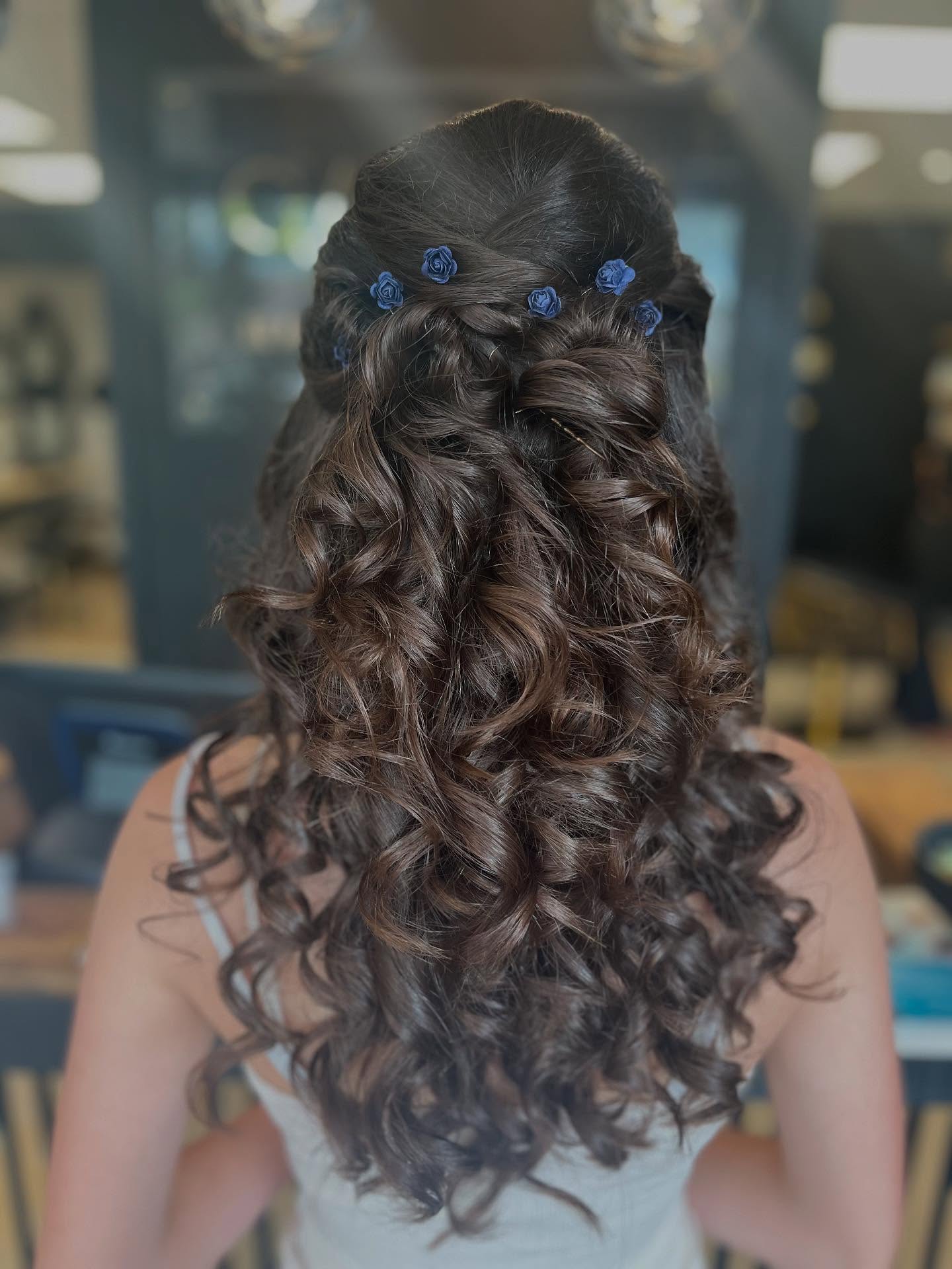 Romantic Half-Up Curly Hairstyle with Floral Accents